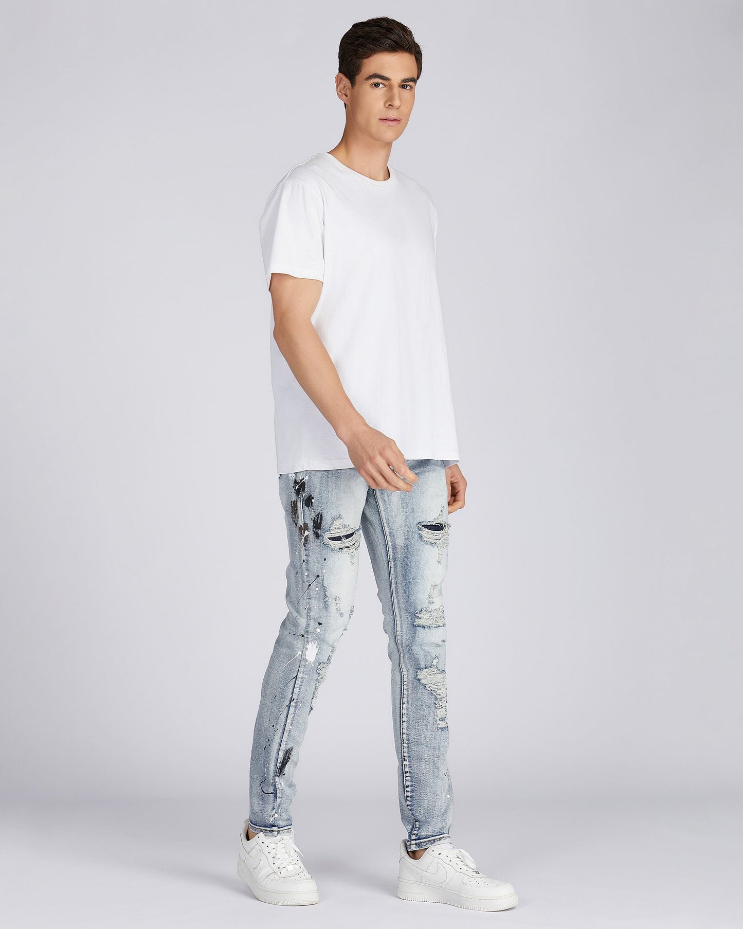 Logeqi distressed blue jeans styled with a white t-shirt and sneakers for a casual look