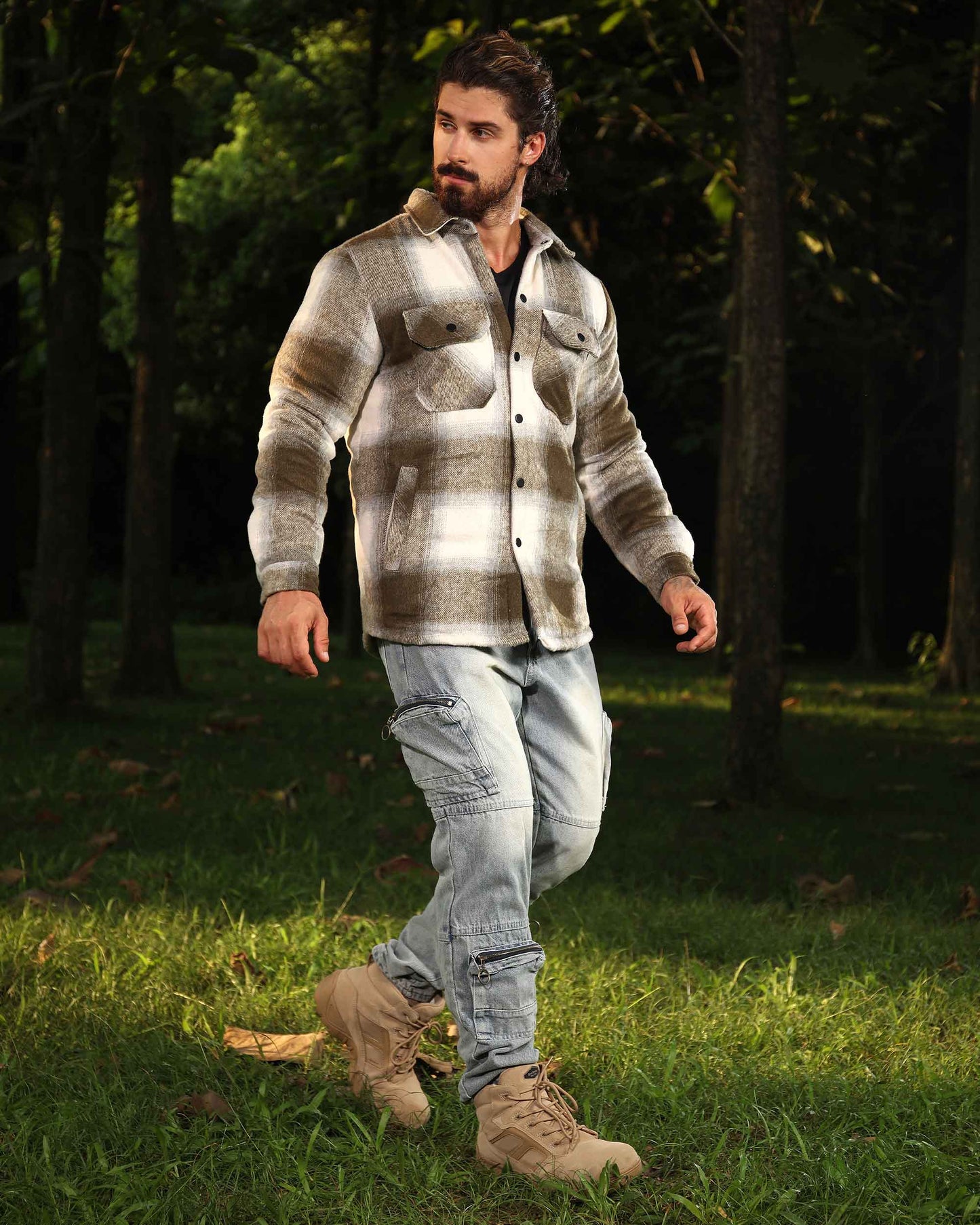 Man wearing Logeqi distressed cargo jeans with multiple pockets paired with a plaid shirt and tan boots