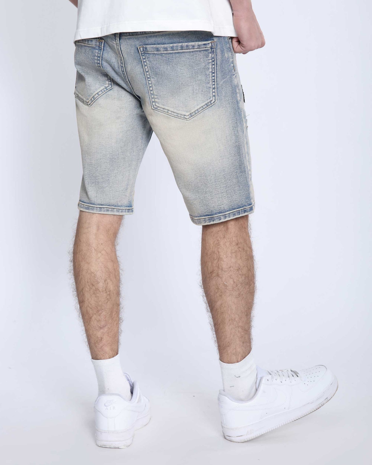 Logeqi distressed denim shorts men in light wash with back pockets worn with white sneakers