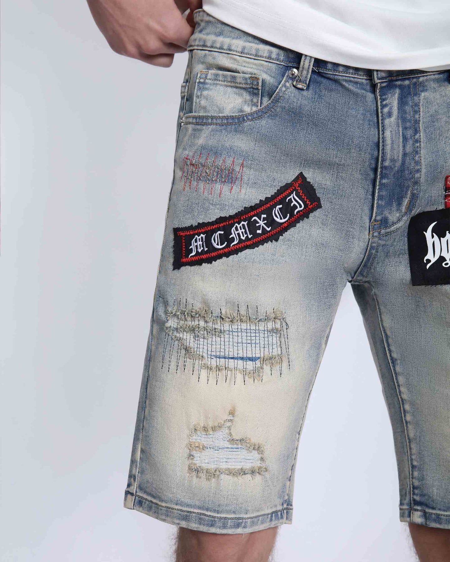 Logeqi distressed denim shorts men with patch and ripped details in light blue wash