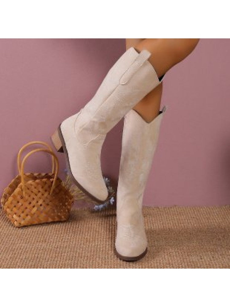 Wholesale7 beige embroidered thigh-high boots with low block heels worn with a woven handbag