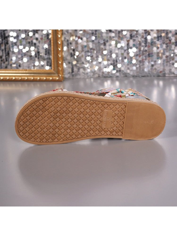 Sole view of wholesale7 floral print flat sandals showing textured rubber outsole for grip