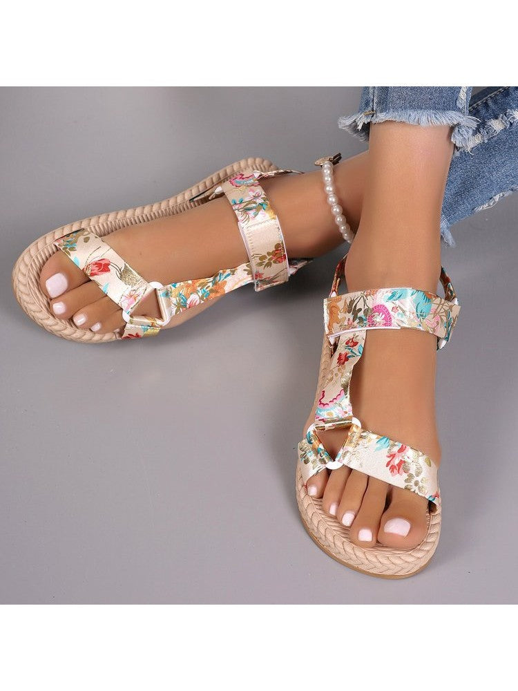 Floral print flat sandals featuring adjustable straps and a braided sole design