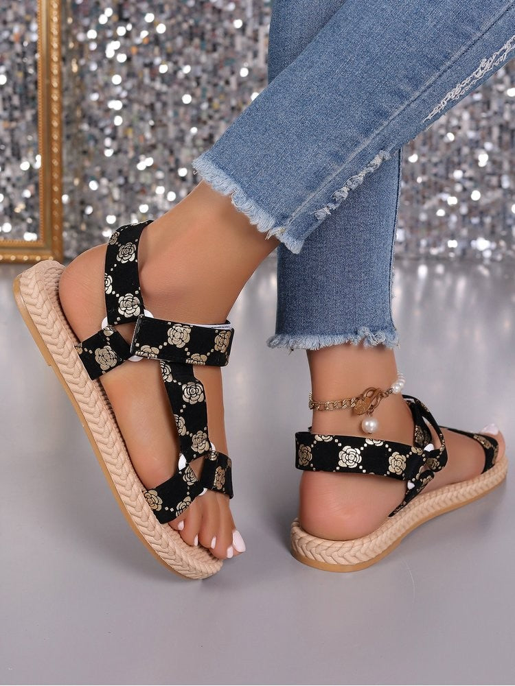 Wholesale7 floral print flat sandals in black with white flowers worn with frayed hem jeans