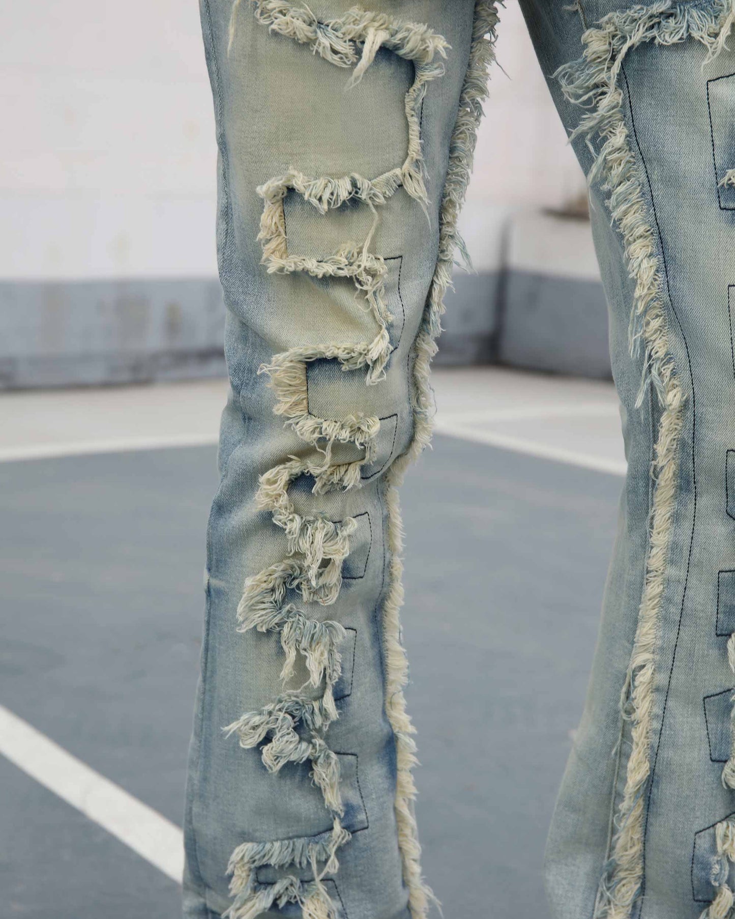 Logeqi fringe flared jeans in light wash denim with detailed frayed edges on legs