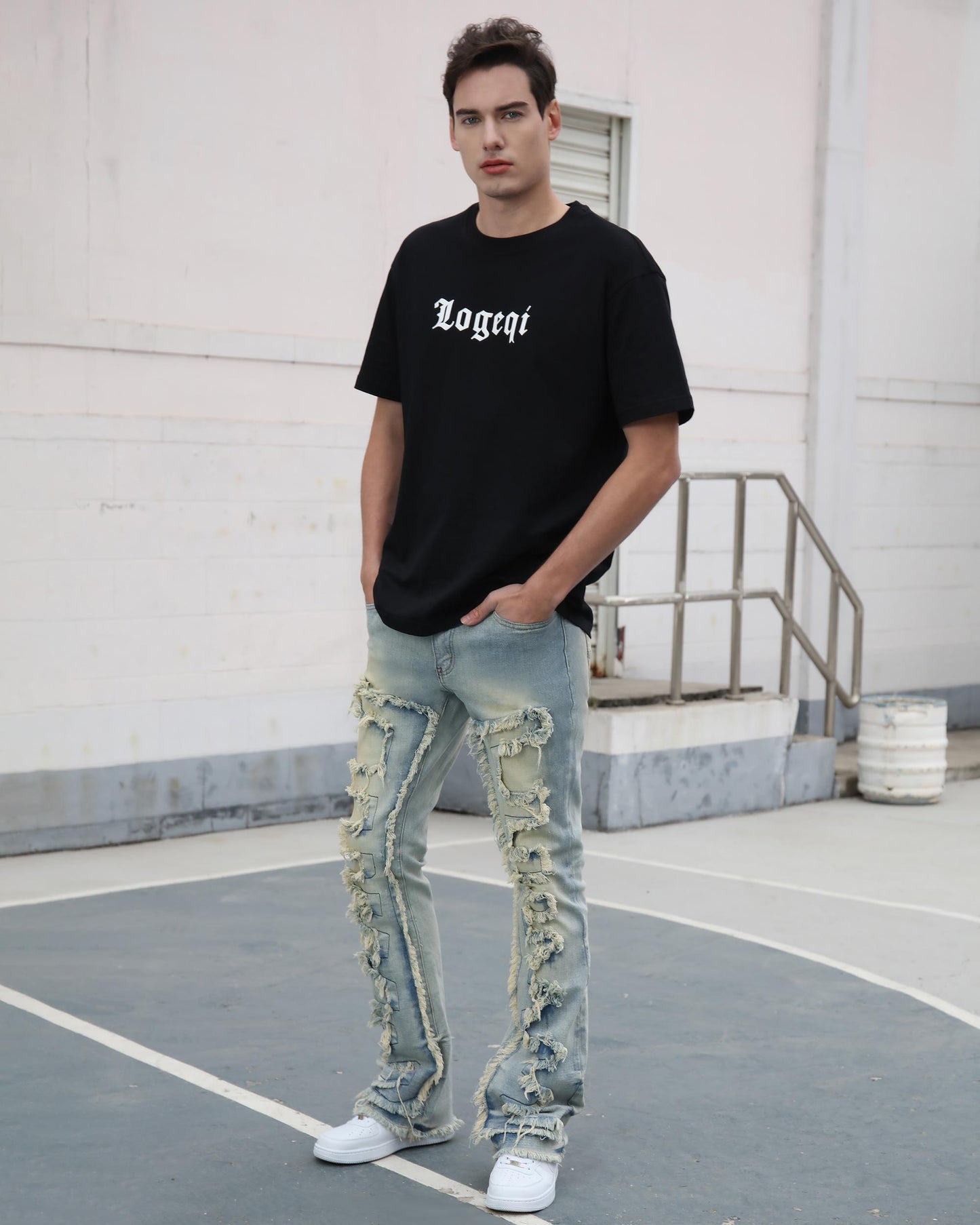 Logeqi fringe flared jeans with heavy ripped fringe details worn by male model with black t-shirt