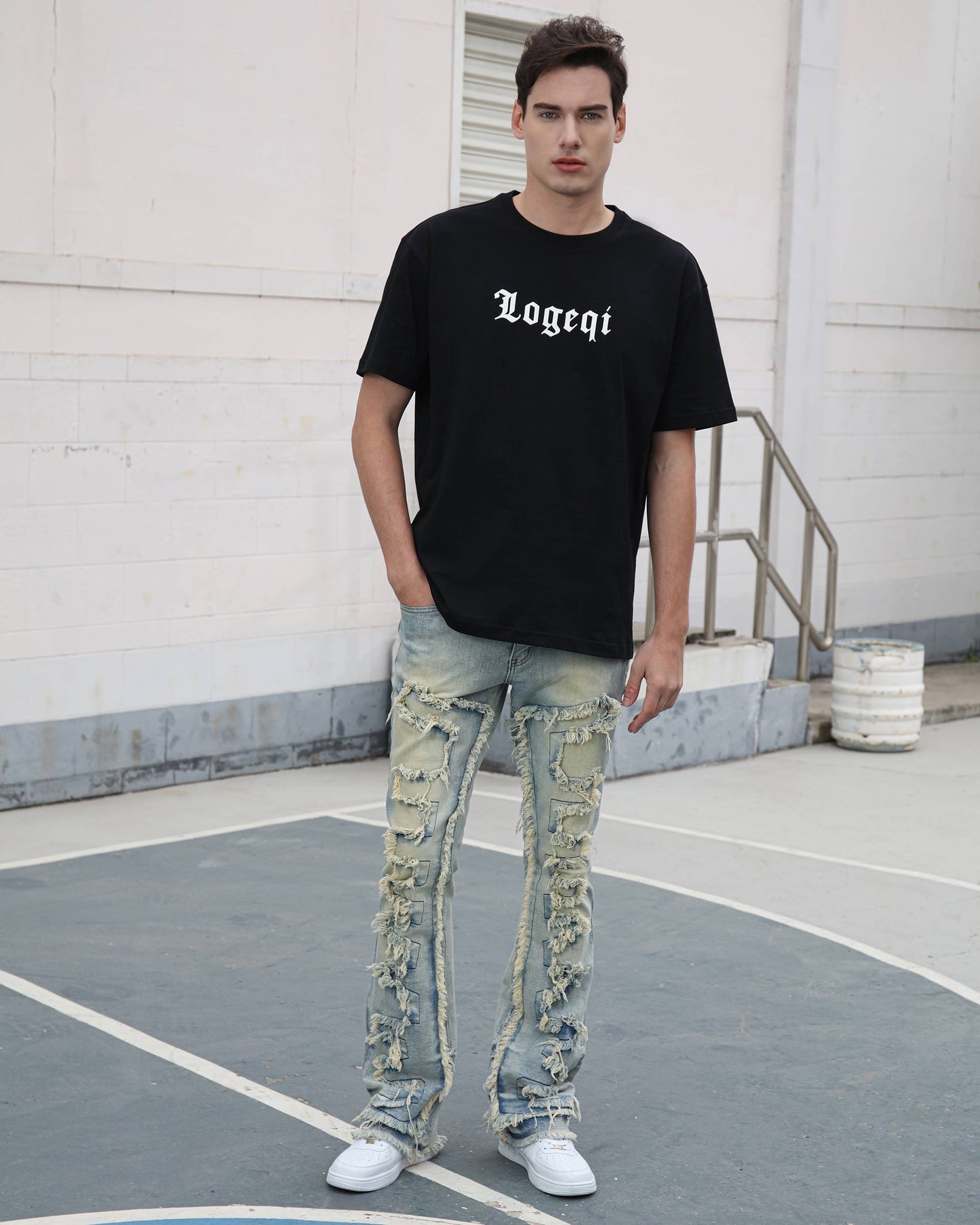 Logeqi fringe flared jeans with distressed detailing worn by a male model with black t-shirt and white sneakers