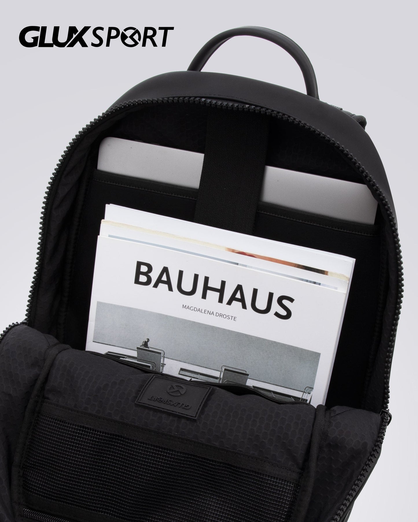 GLUX men's backpack with padded compartment holding a laptop and magazine for stylish convenience