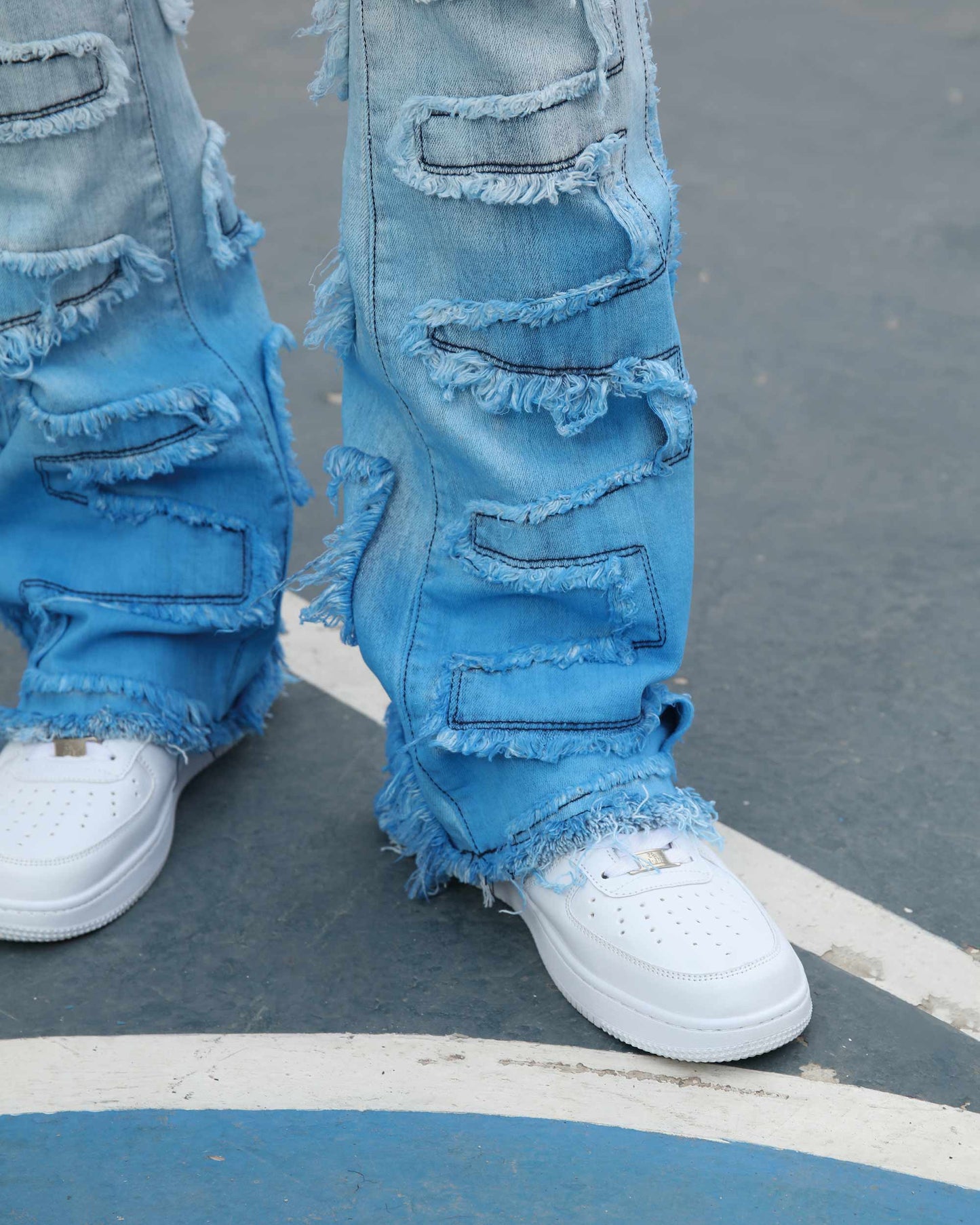 Logeqi gradient blue flare jeans with distressed patches worn with white sneakers