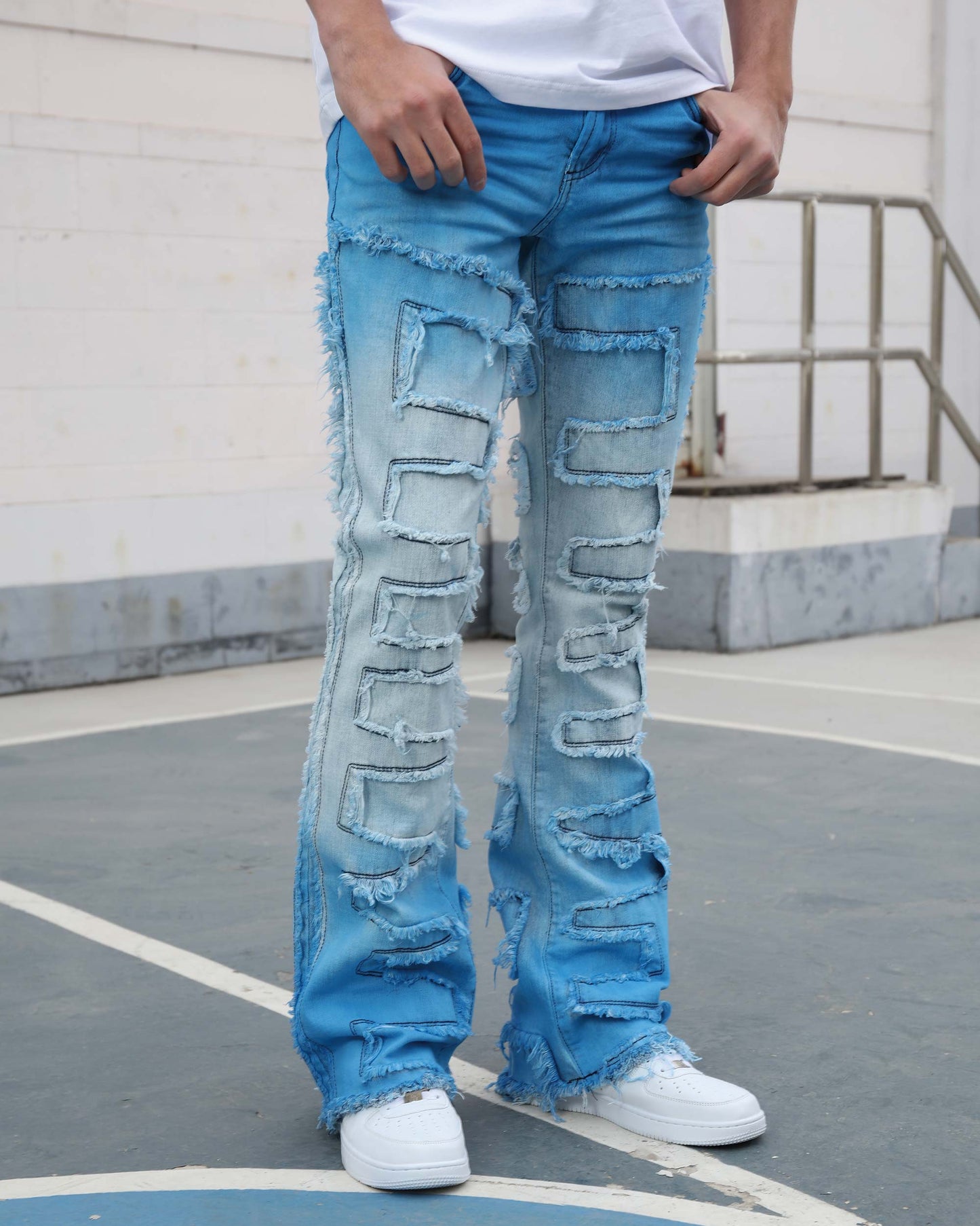 Logeqi gradient blue flare jeans with distressed detailing worn with white sneakers