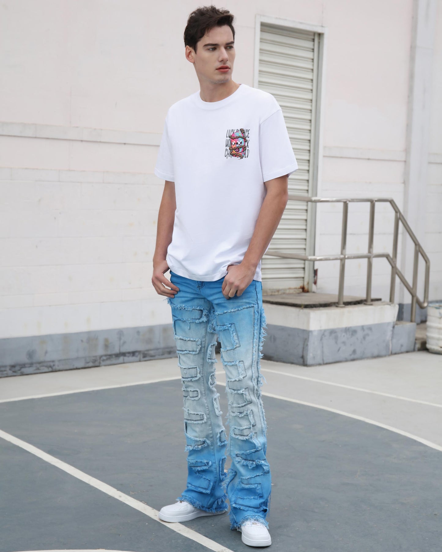Man wearing Logeqi gradient blue flare jeans with distressed detailing and white casual t-shirt