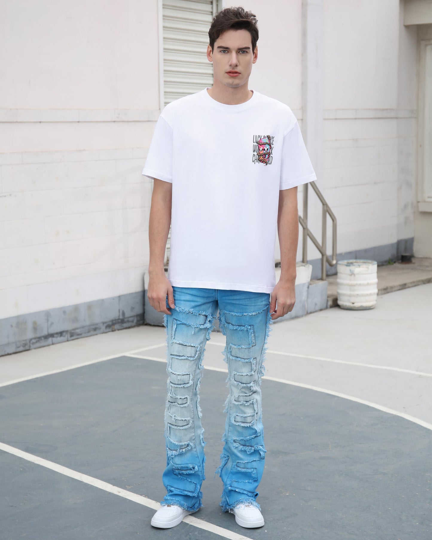 Logeqi gradient blue flare jeans with distressed details worn by male model in white sneakers
