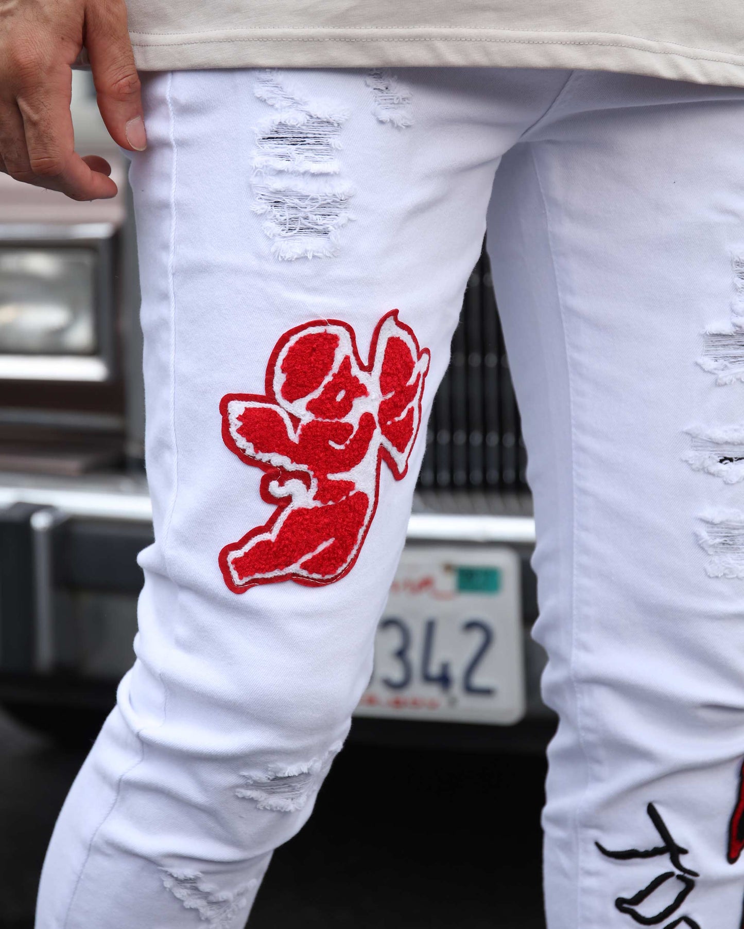 Logeqi graffiti embroidered jeans with red designs and distressed details for a stylish look