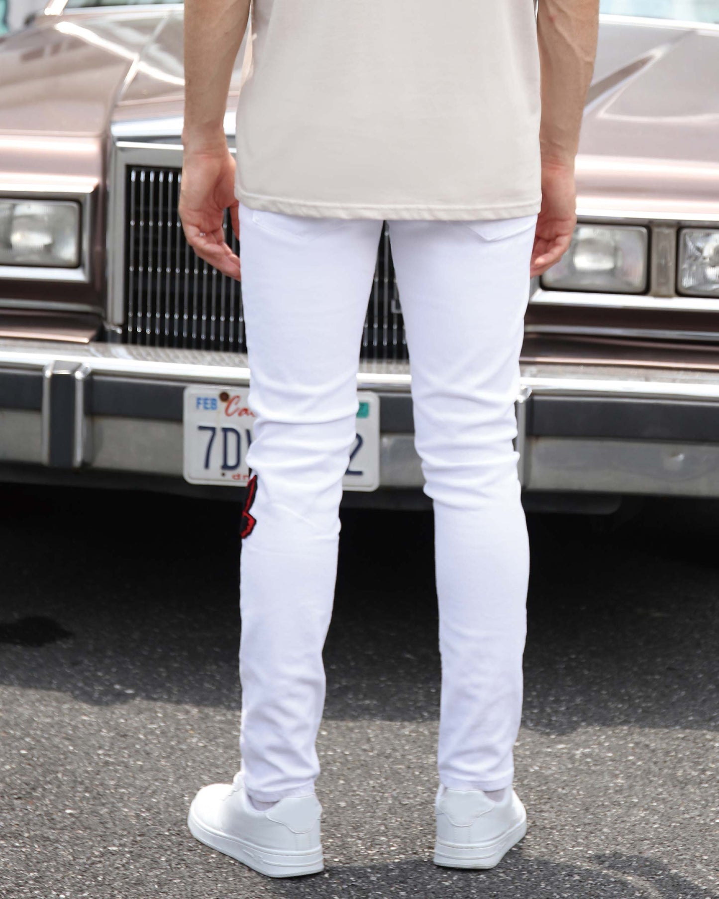 Logeqi graffiti embroidered jeans in white with stylish embroidery detail on the leg