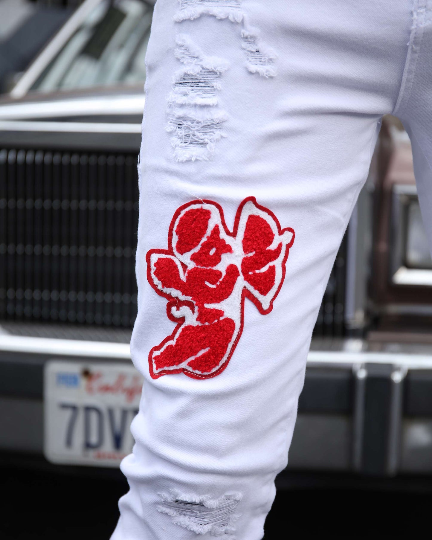 Logeqi graffiti embroidered jeans with unique red design and distressed details for a trendy urban style