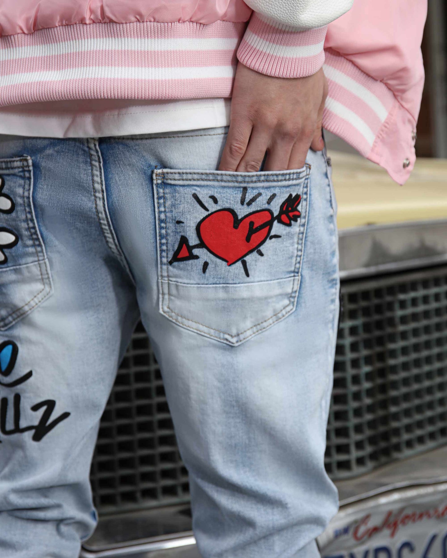 Logeqi graffiti painted jeans featuring colorful designs and a relaxed fit for a trendy look