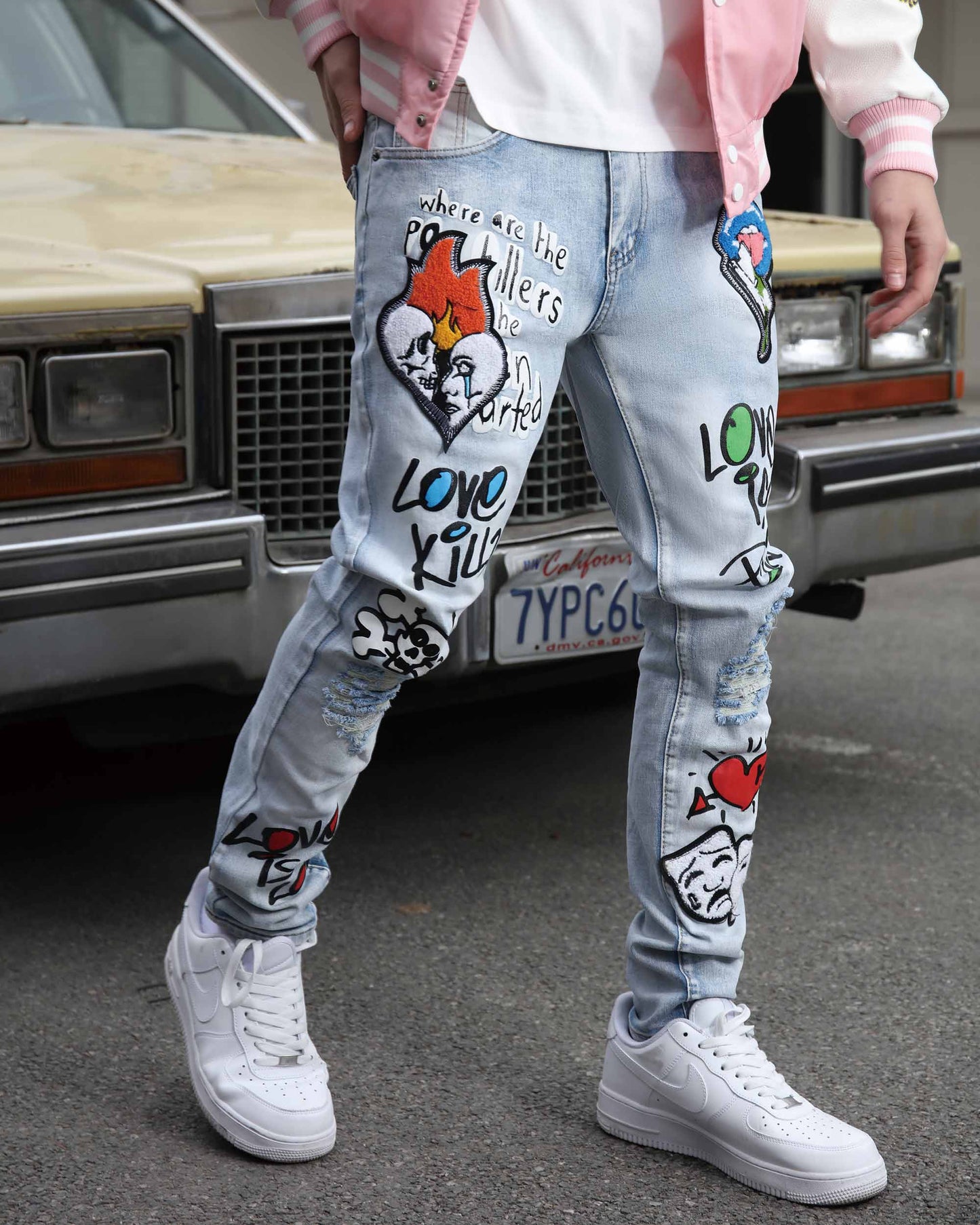 Logeqi graffiti painted jeans featuring artistic designs and distressed detailing for a trendy look