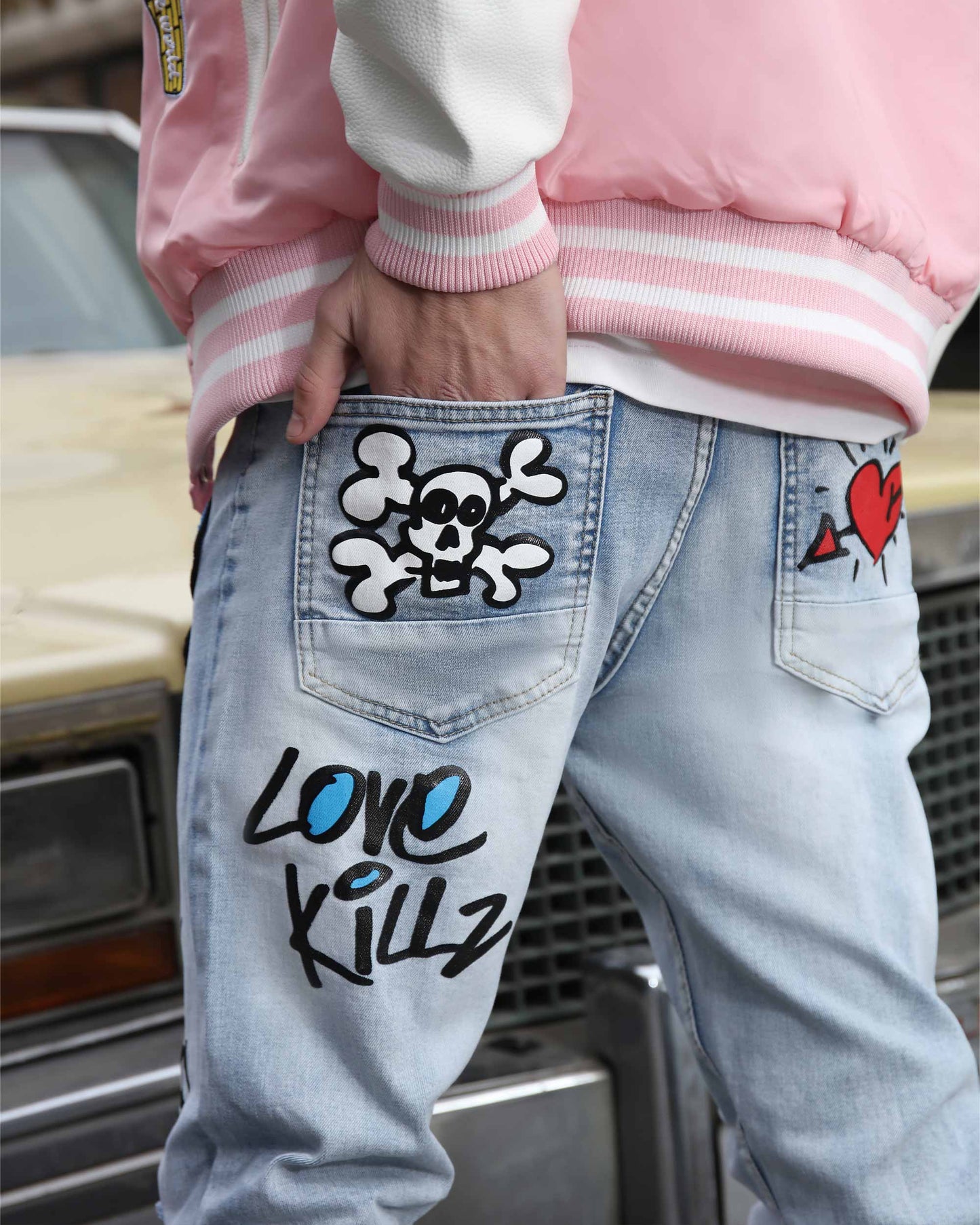 Logeqi graffiti painted jeans featuring artistic skull and heart designs for a bold streetwear style