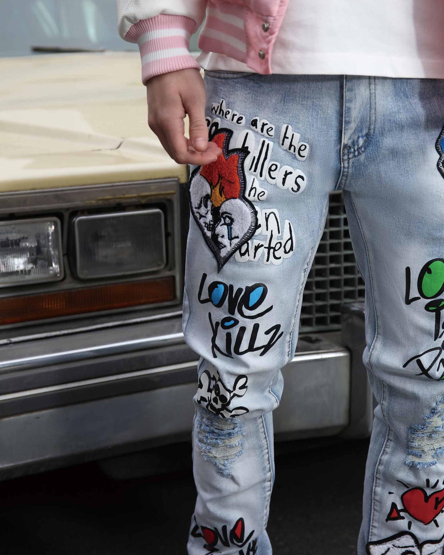 Logeqi graffiti painted jeans with colorful designs, perfect for a trendy streetwear look