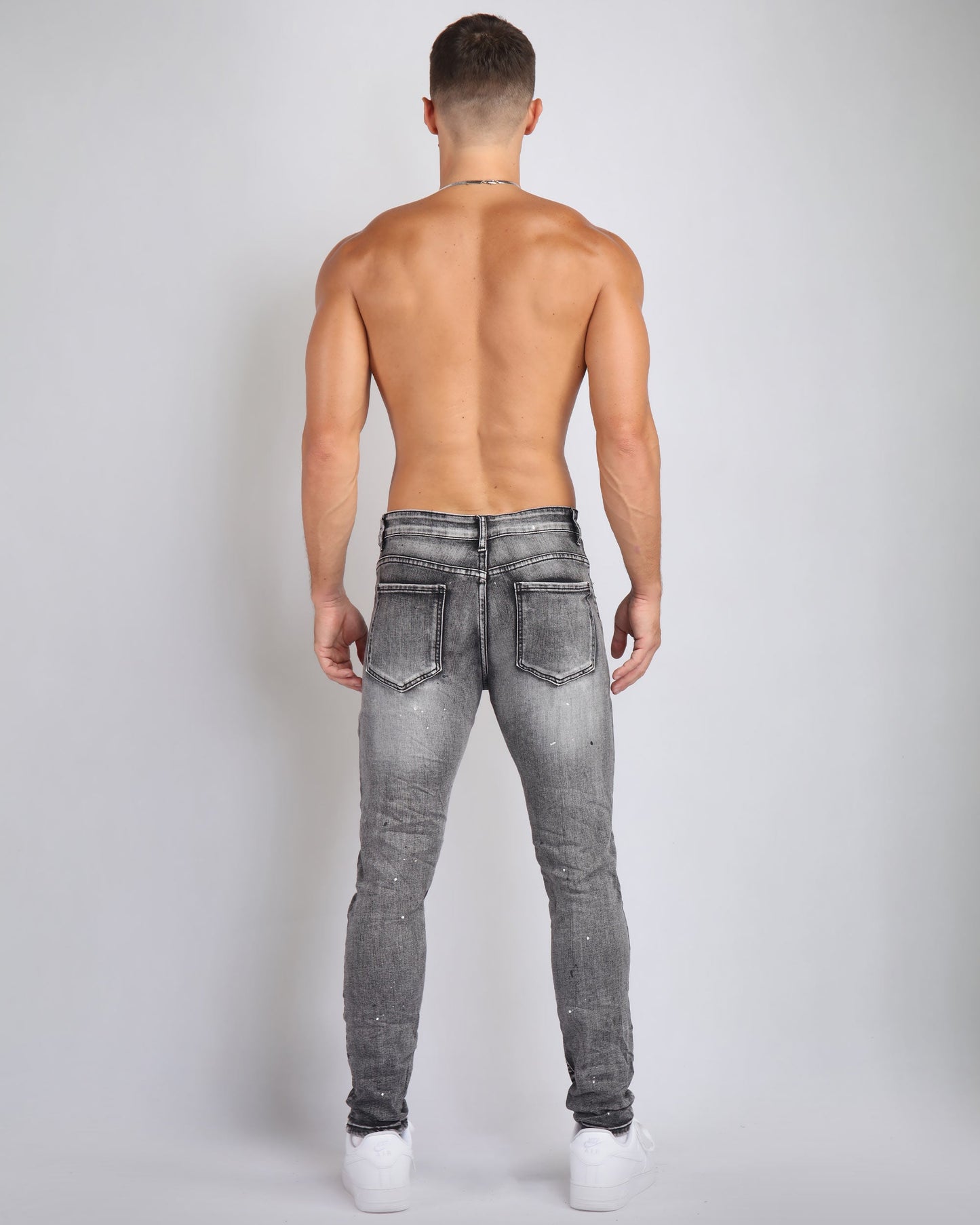 Men's Logeqi graffiti ripped jeans in gray with a fitted design and distressed details