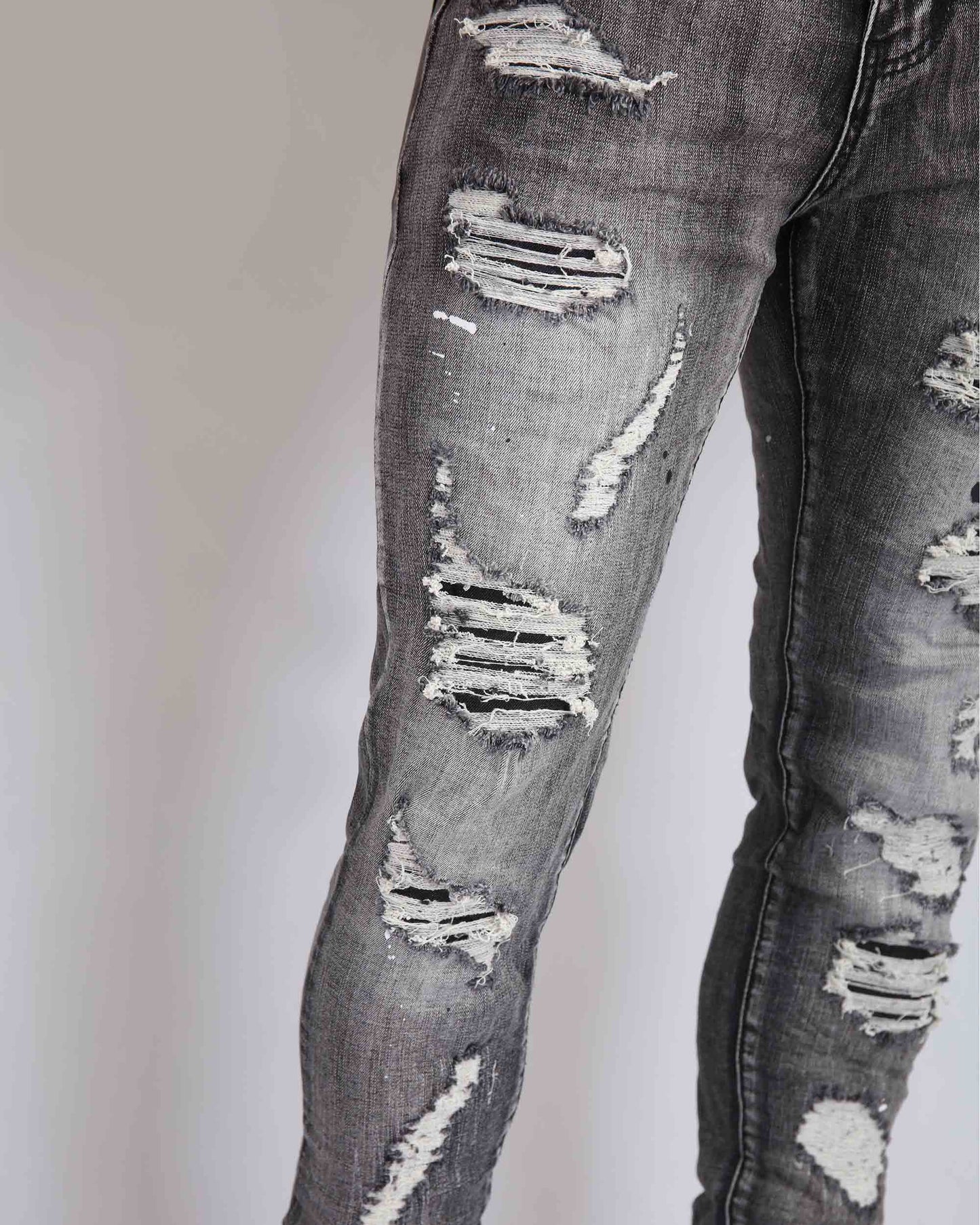 Logeqi graffiti ripped jeans featuring a distressed design with multiple tear details