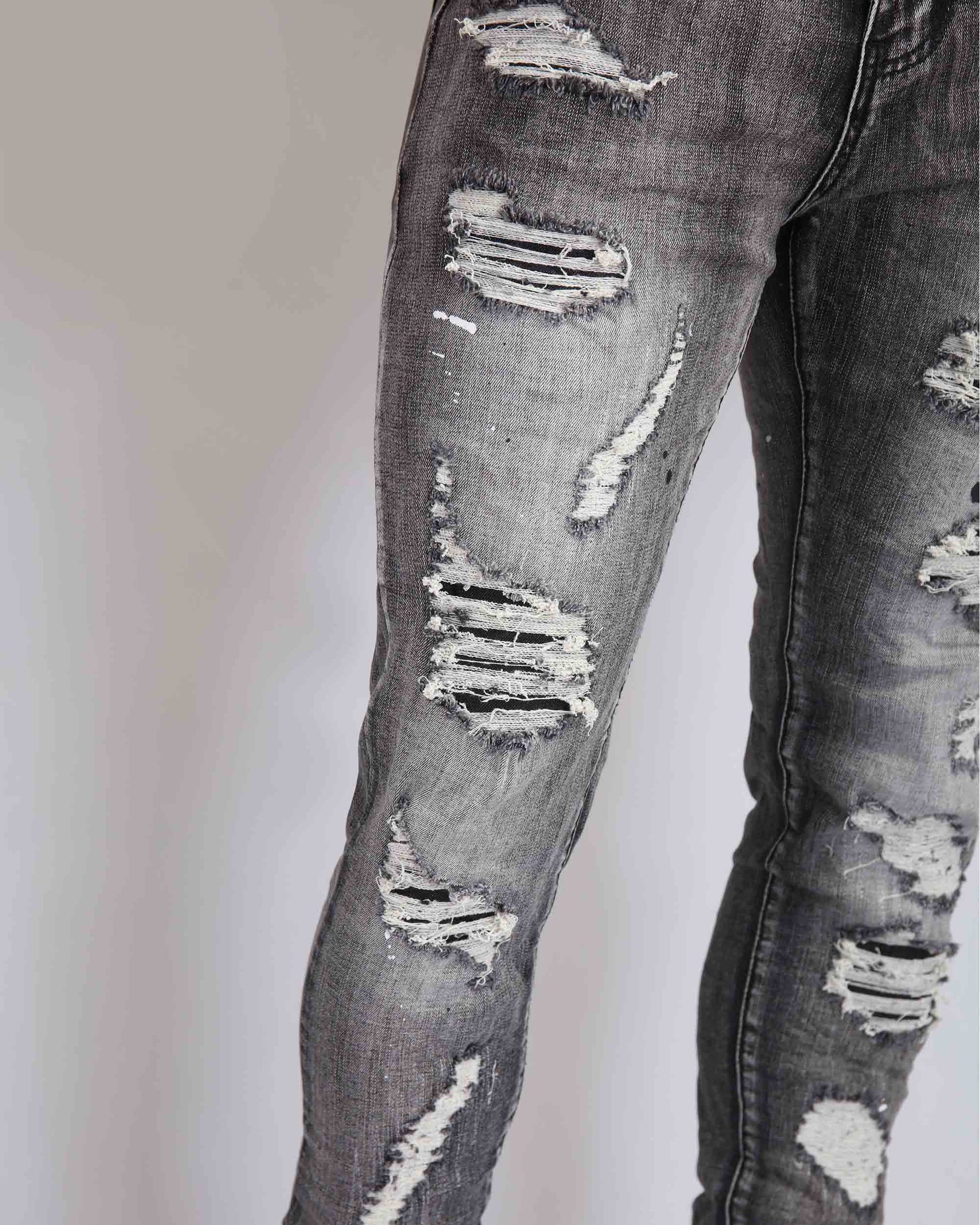 Logeqi graffiti ripped jeans featuring a distressed design with multiple tear details