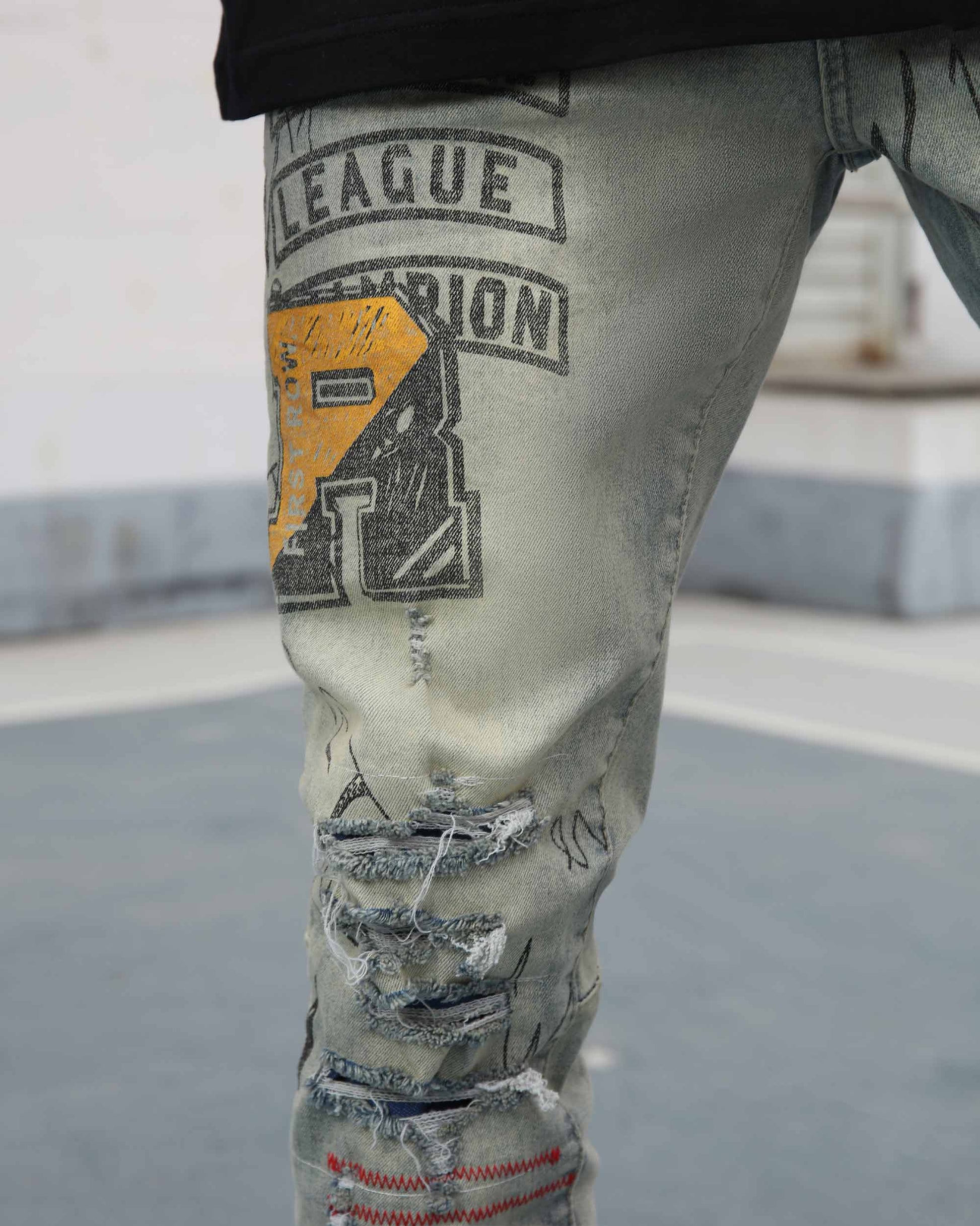 Logeqi graffiti ripped jeans featuring unique designs and distressed detailing on a light wash fabric