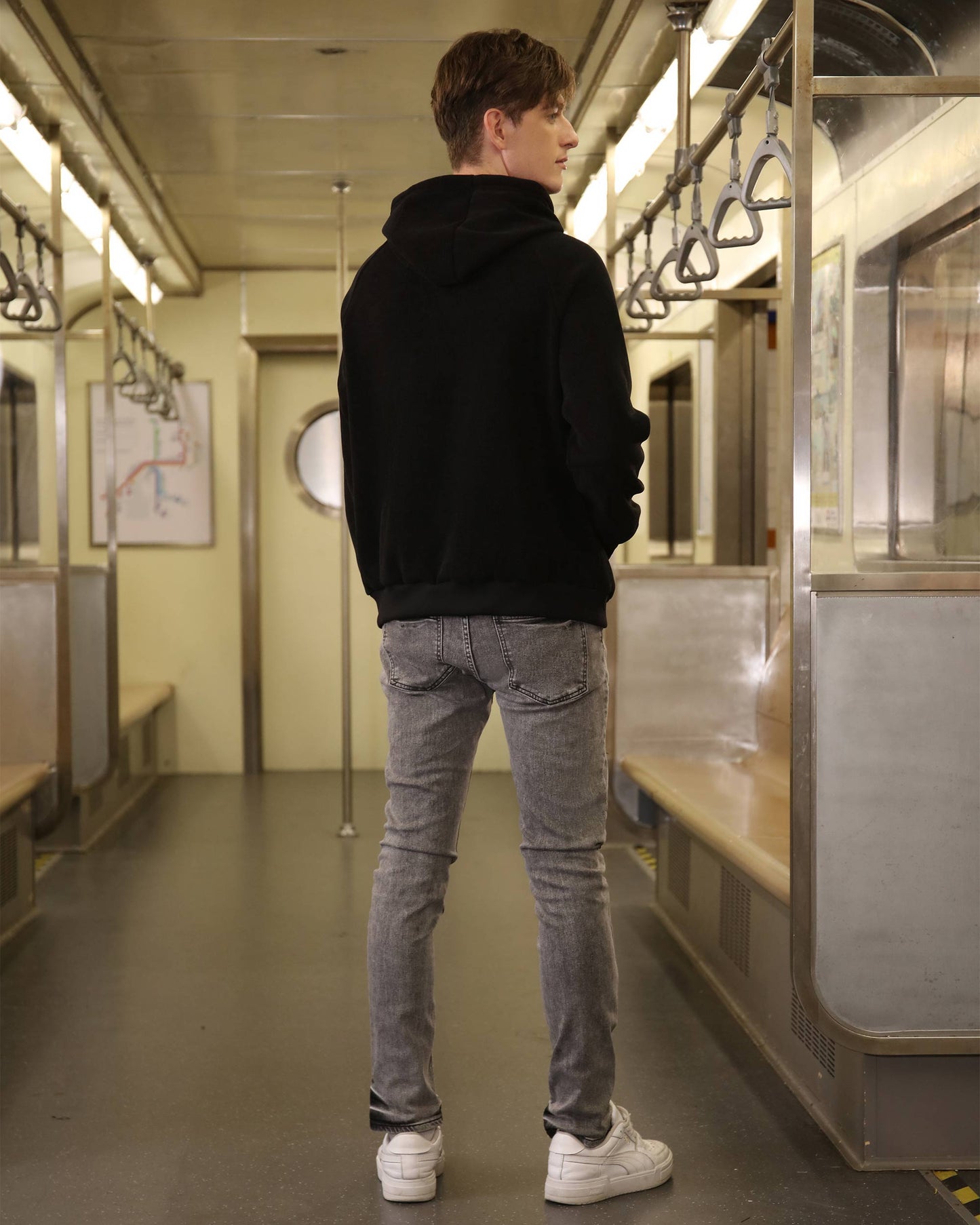 Logeqi gray ripped jeans men worn by man standing in subway car with black hoodie and white sneakers