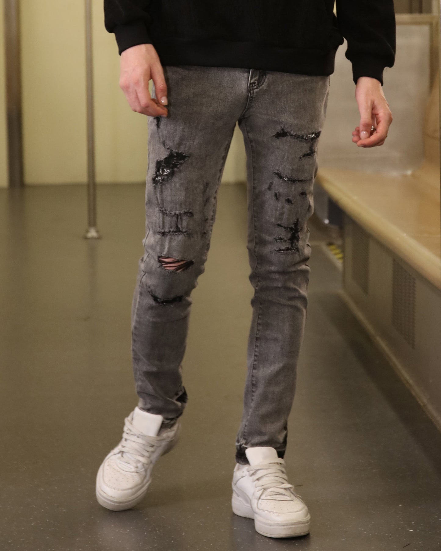 Logeqi gray ripped jeans men styled with white sneakers and black sweatshirt for casual wear