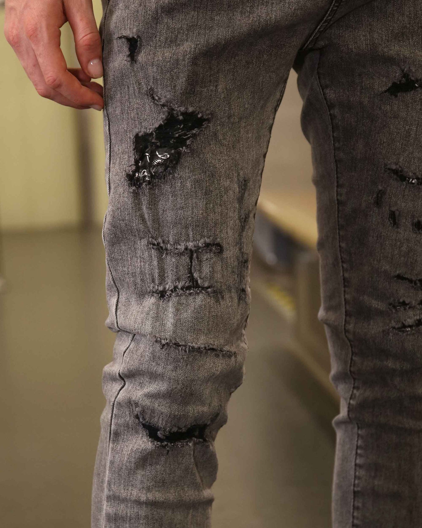 Logeqi gray ripped jeans men showing distressed fabric and detailed stitching on thigh