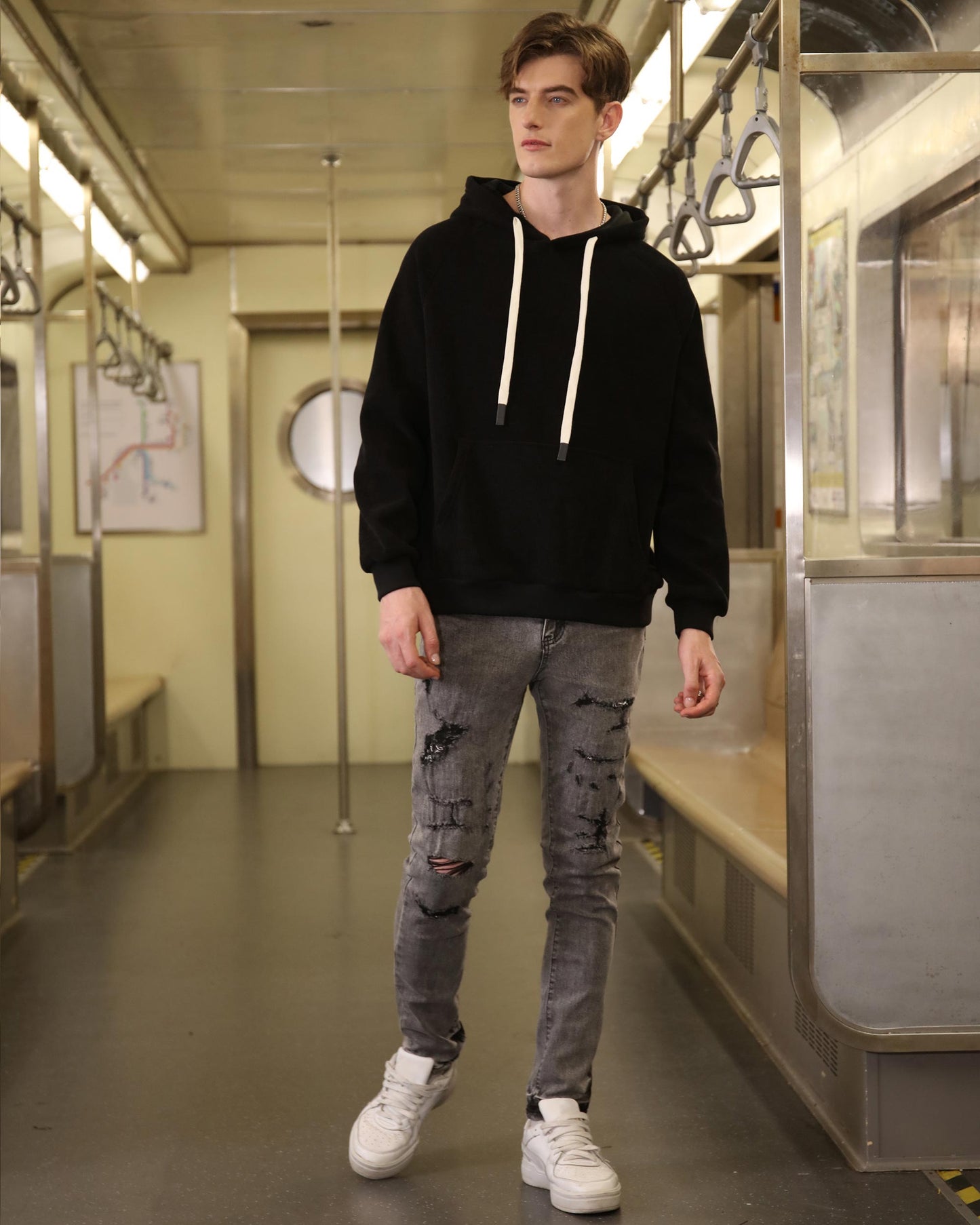 Gray ripped jeans men from Logeqi worn by a male model paired with black hoodie and white sneakers