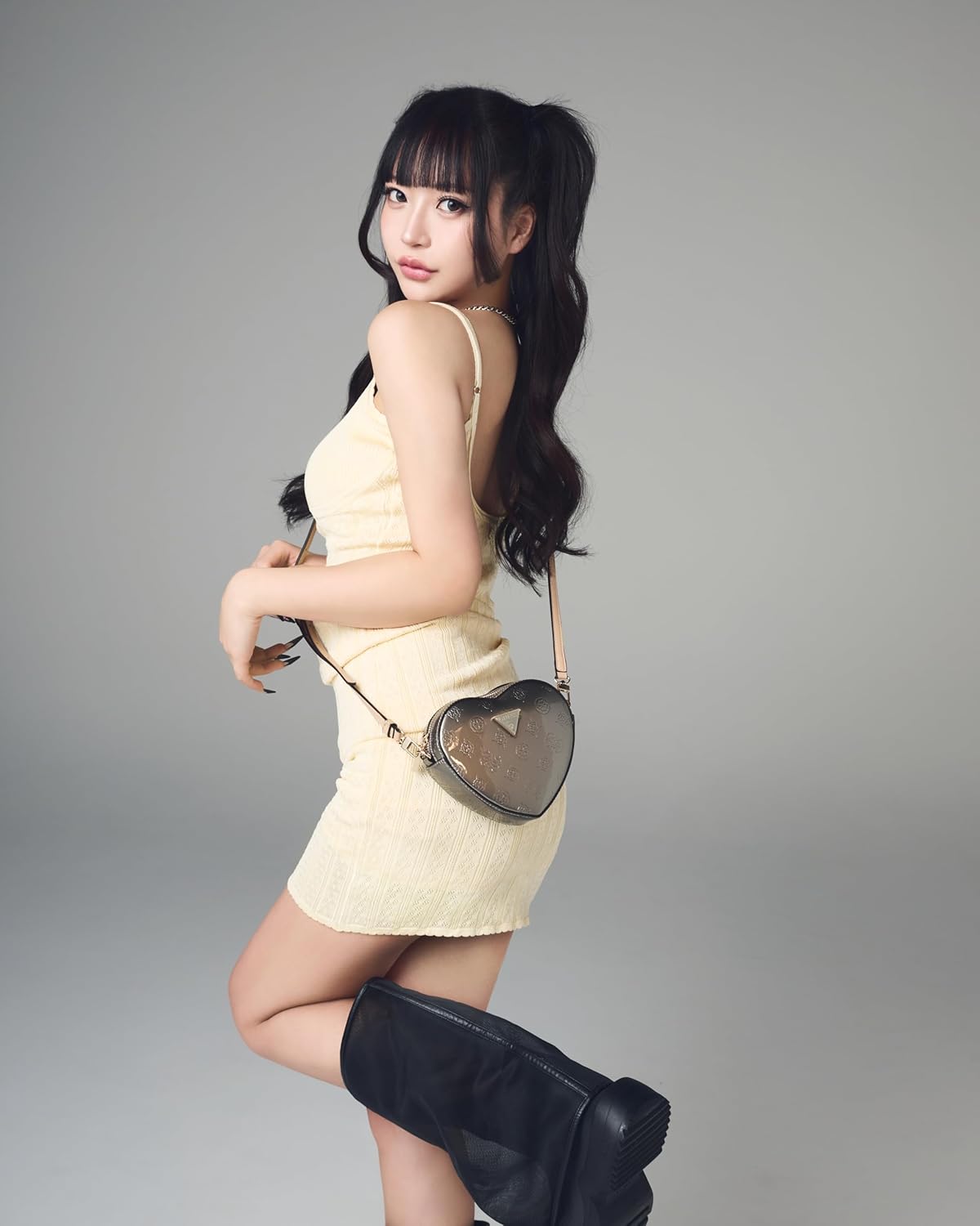Modan Online black heart shaped handbag for women, stylishly worn crossbody with a chic outfit