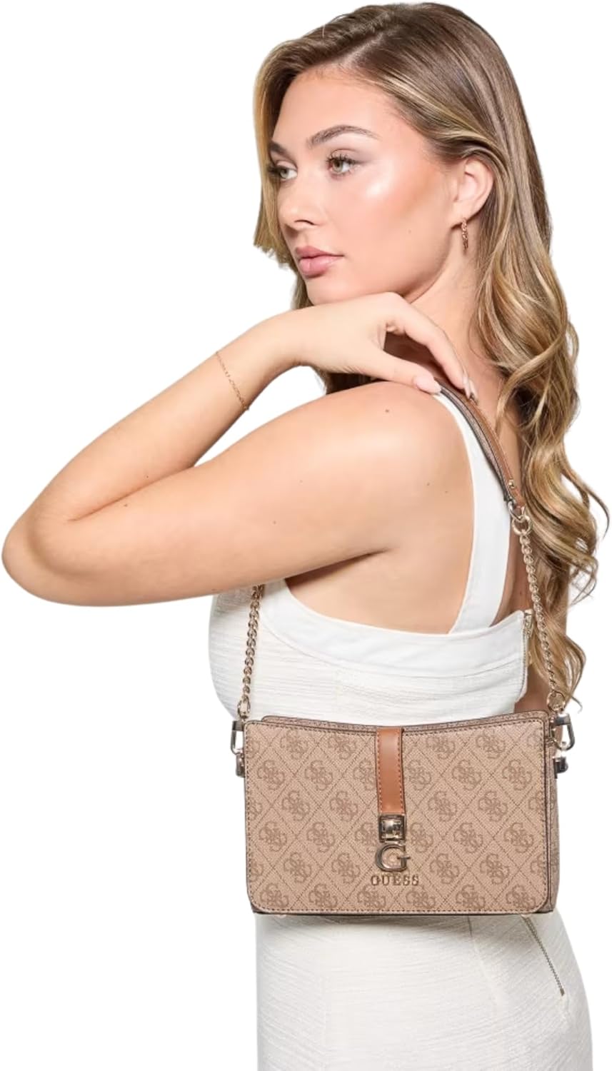 Model wearing GUESS Zamira shoulder bag beige monogram with chain strap styled over white dress