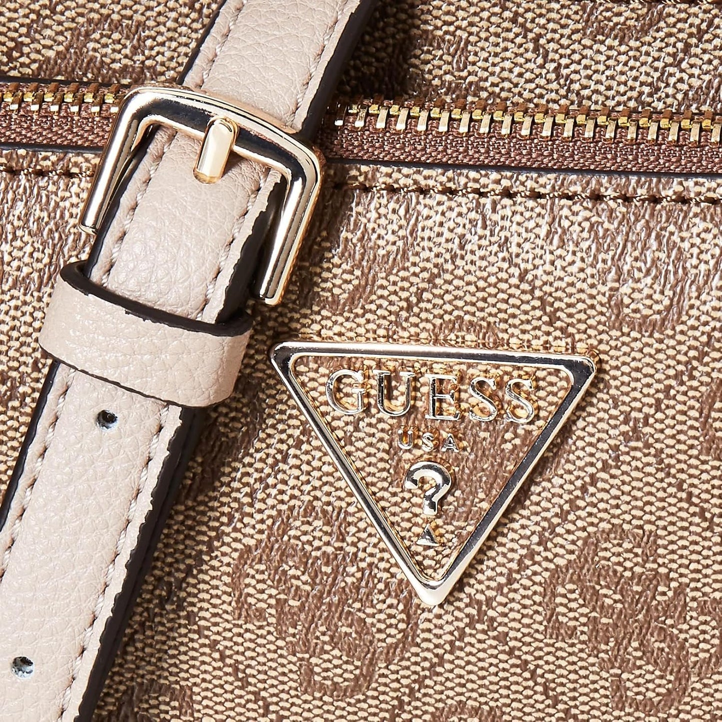 Close-up of GUESS Noelle crossbody bag showing textured fabric and brand emblem
