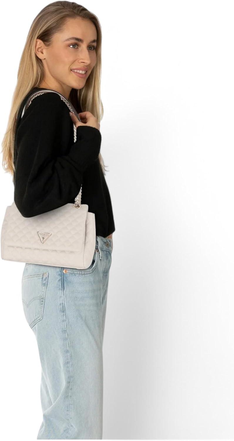 Woman wearing Guess Rianee convertible crossbody bag in light color, styled with casual outfit