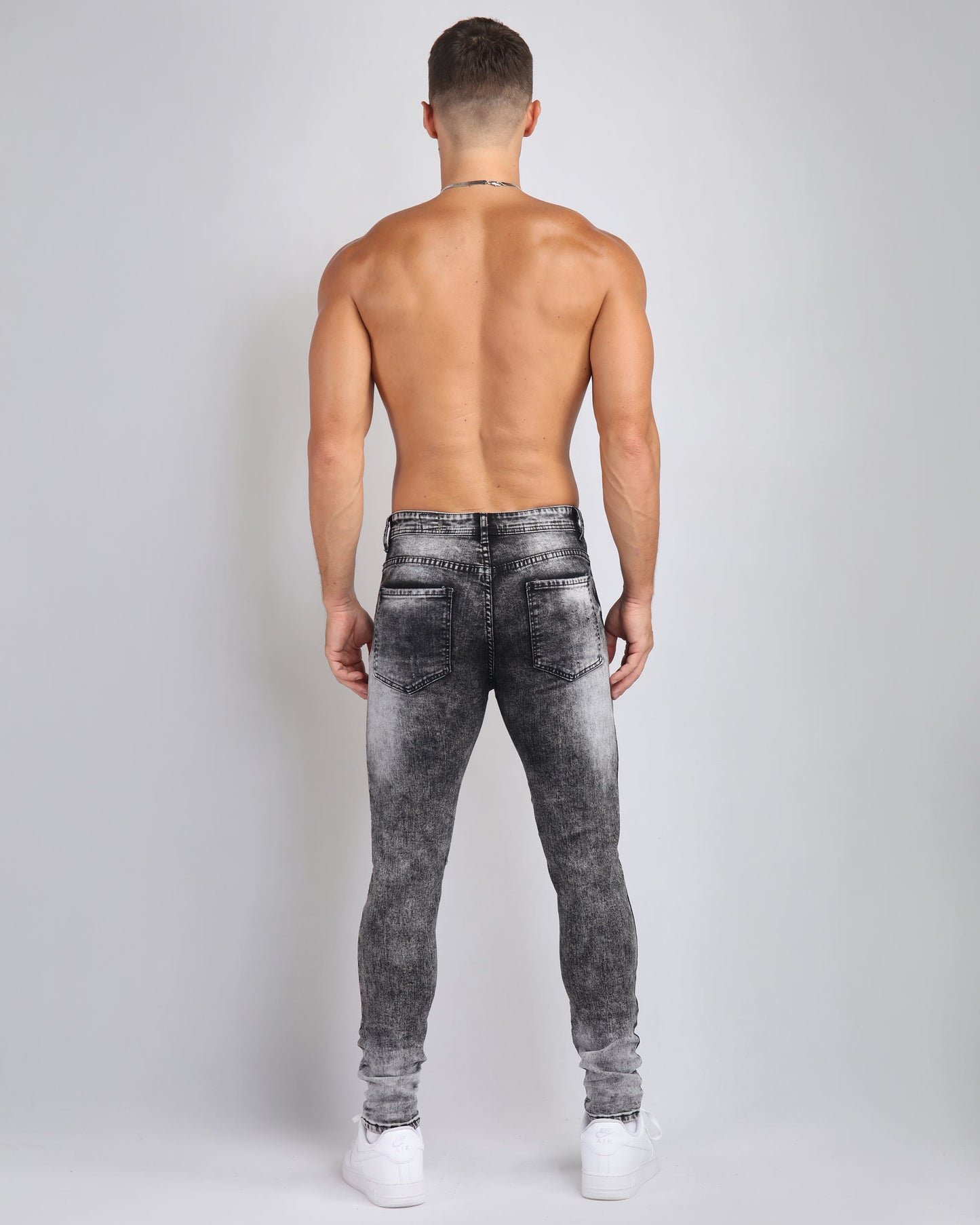 Back view of Logeqi Irregular Wash Ripped Jeans in a stylish gradient design for unique fashion