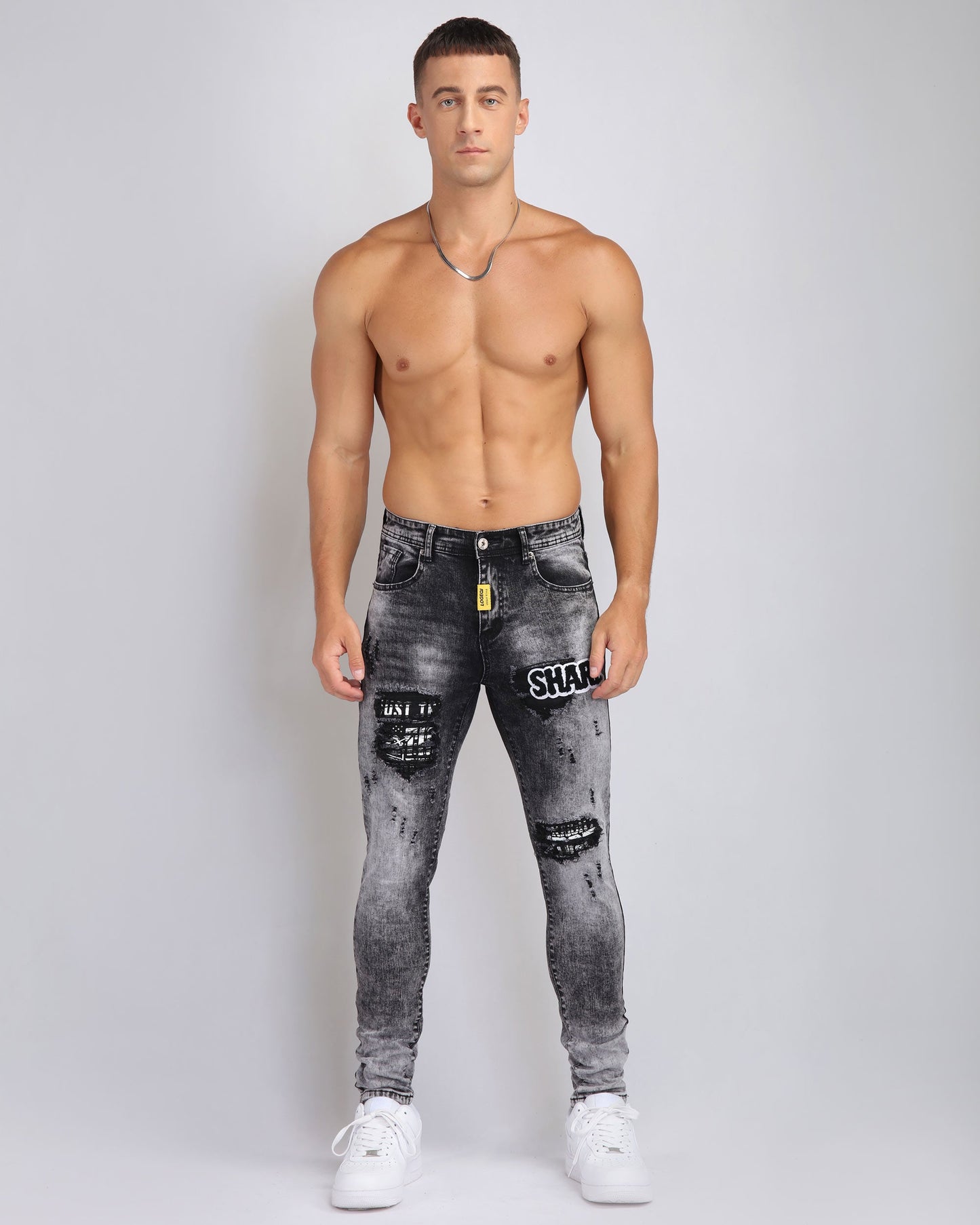 Logeqi Irregular Wash Ripped Jeans in Black with Distressed Patches and Slim Fit Design