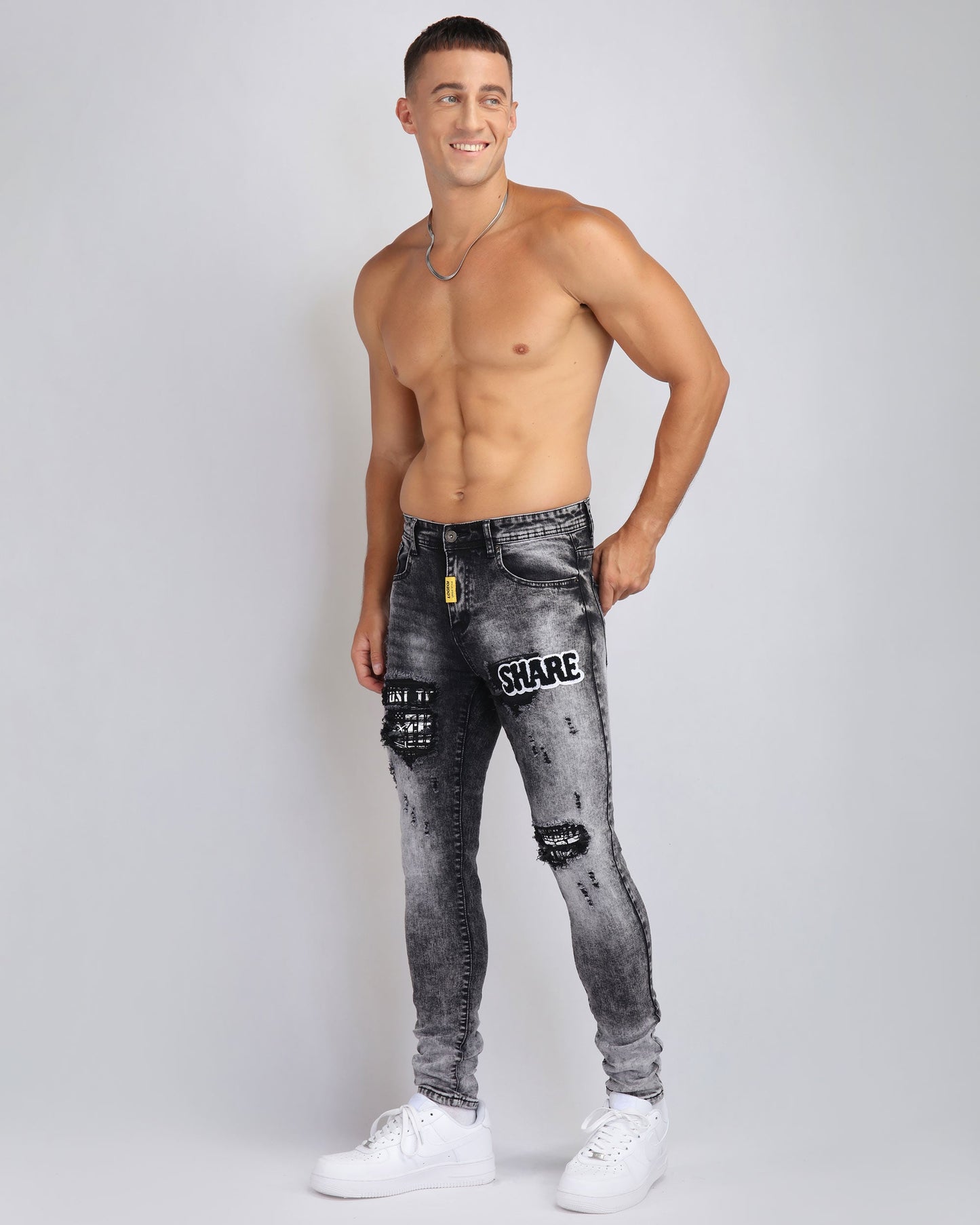 Logeqi Irregular Wash Ripped Jeans on a model with a fitted design and trendy details