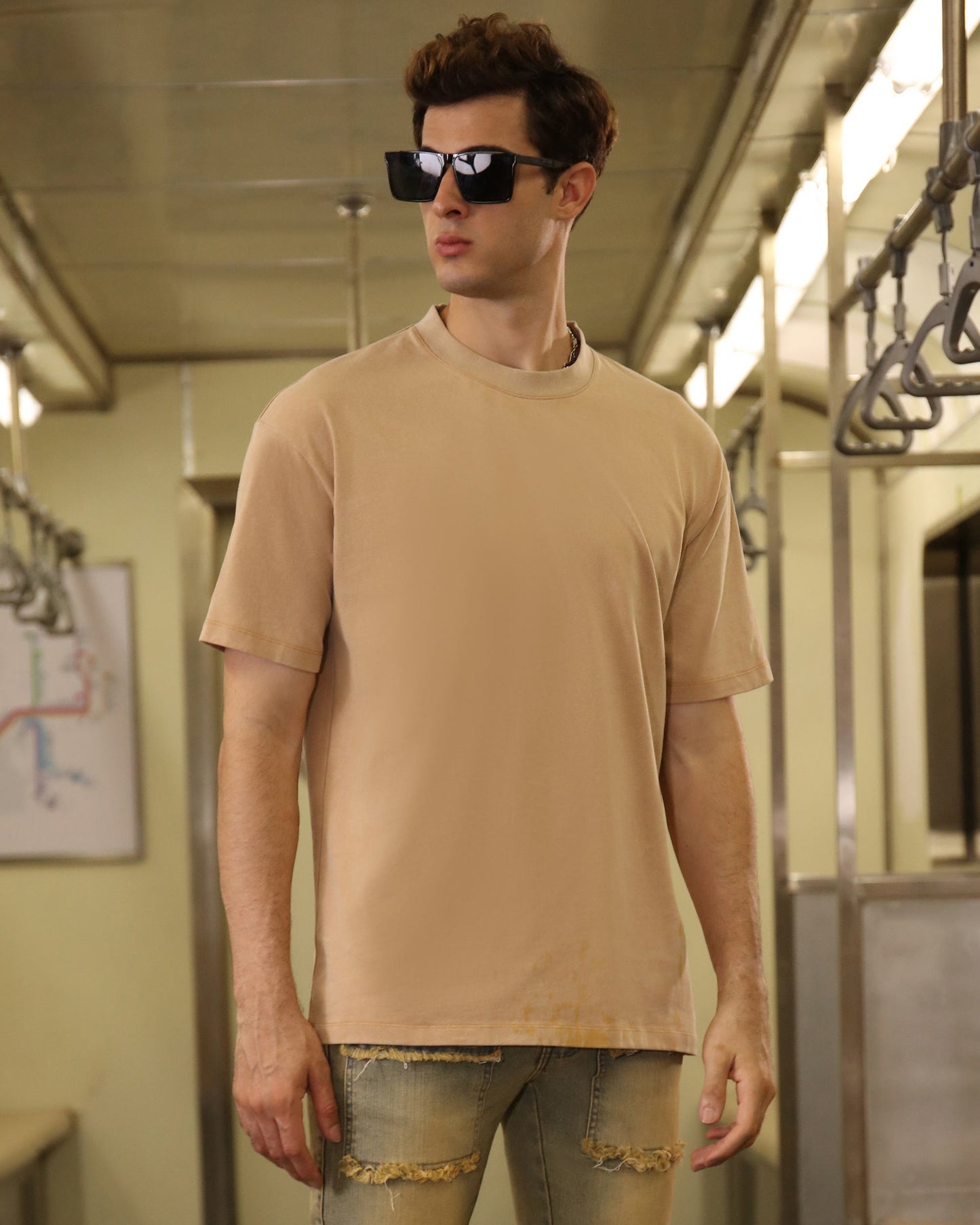 Logeqi khaki crew neck t-shirt worn by a model in a stylish urban setting