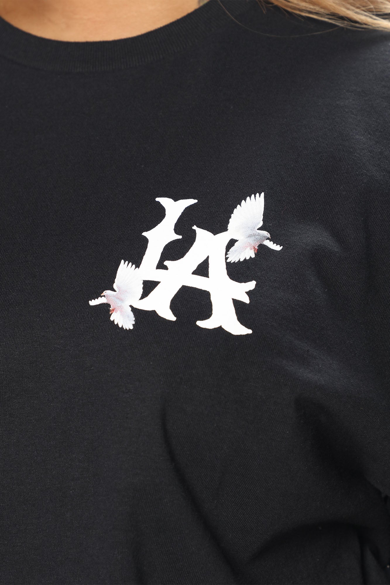 LA City black graphic tee featuring a stylish LA logo and white dove designs