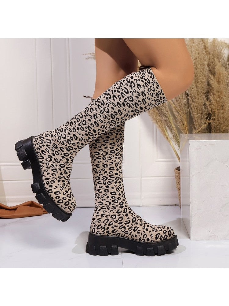 Leopard print chunky heel boots with a stylish knee-high design and bold black sole