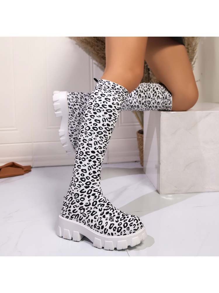 Leopard print chunky heel boots with a stylish design and white chunky sole for trendy outfits