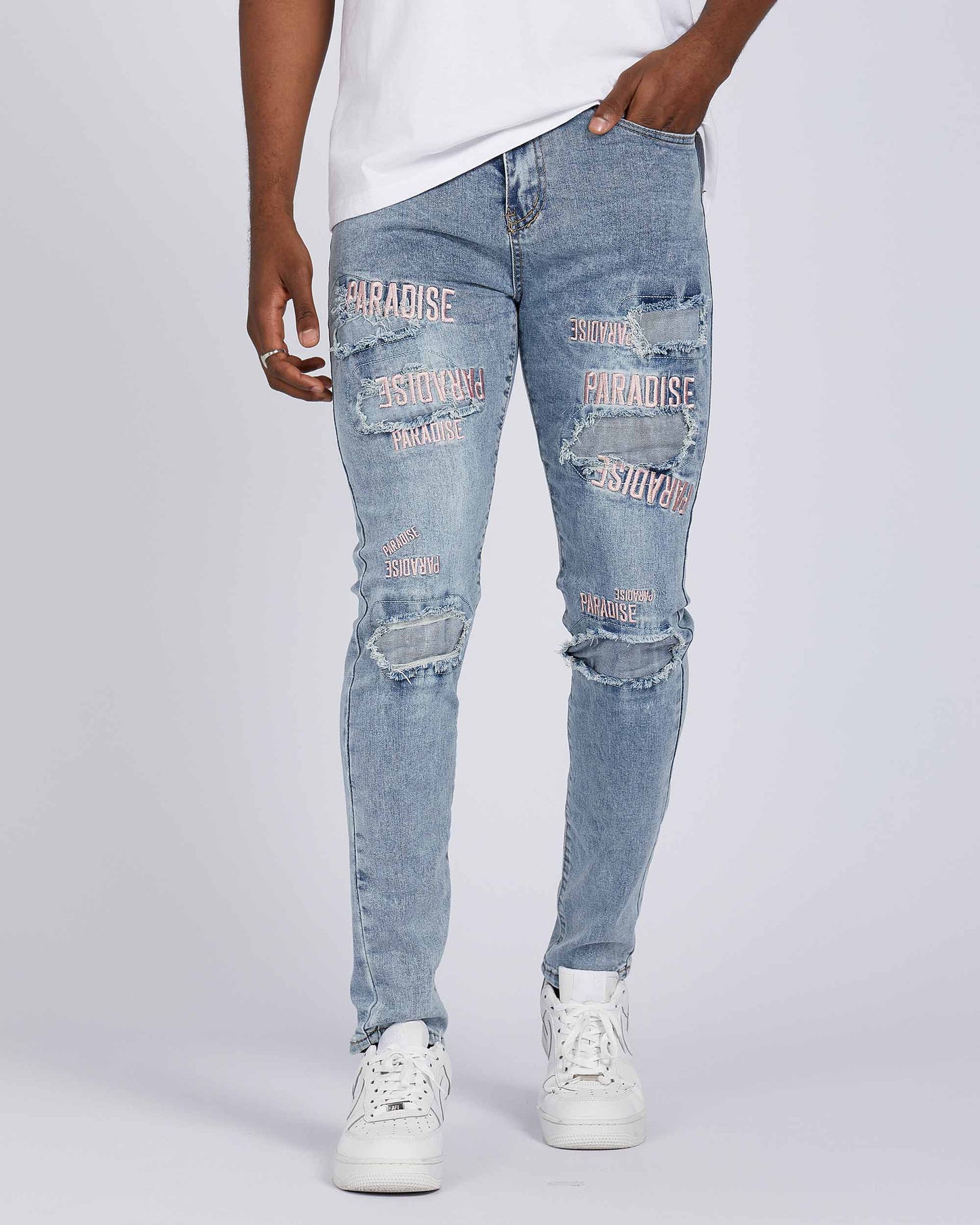 Logeqi light wash blue ripped jeans with graphic prints and a slim fit style for casual wear
