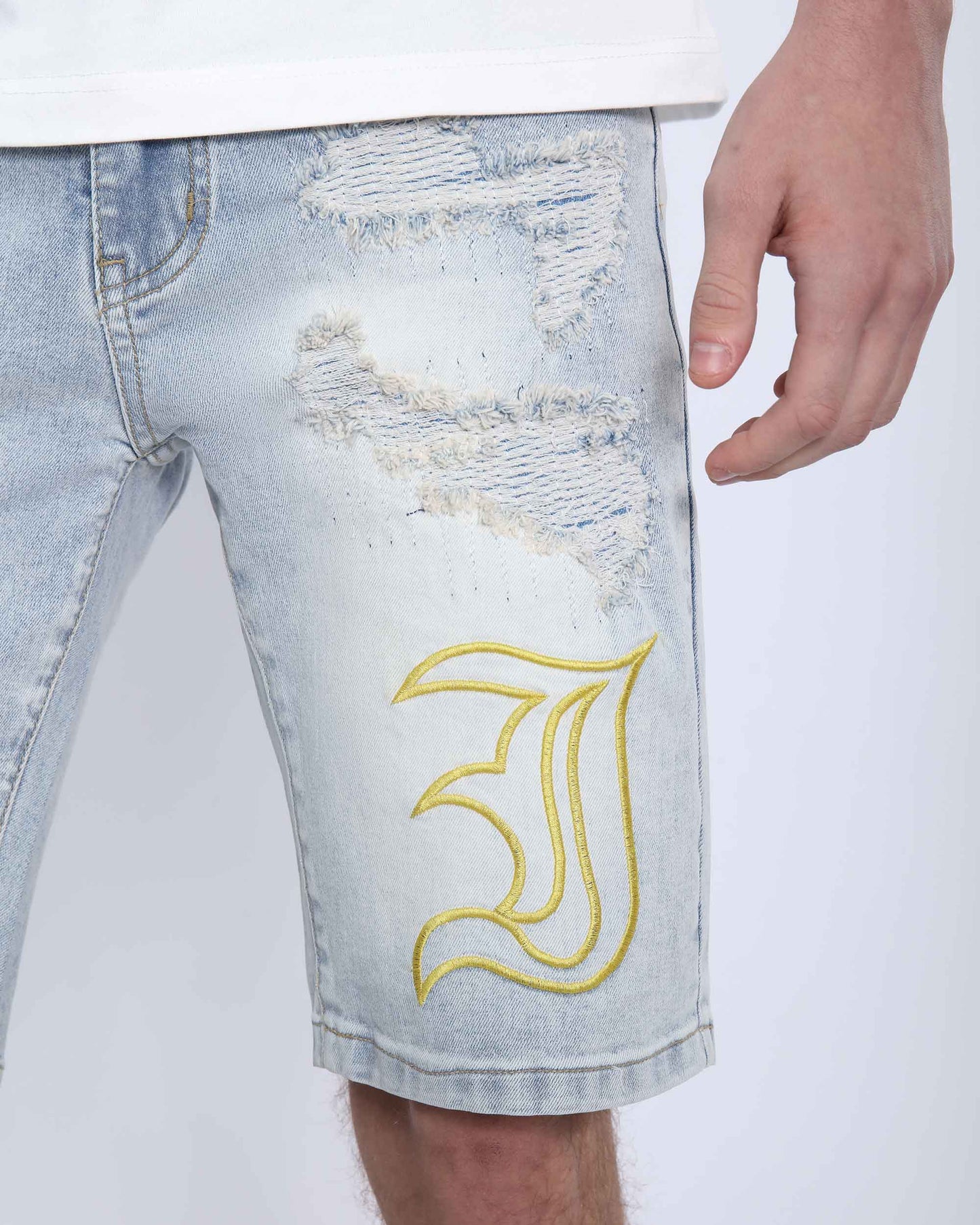Logeqi light wash denim shorts with distressed detailing and embroidered design on the leg