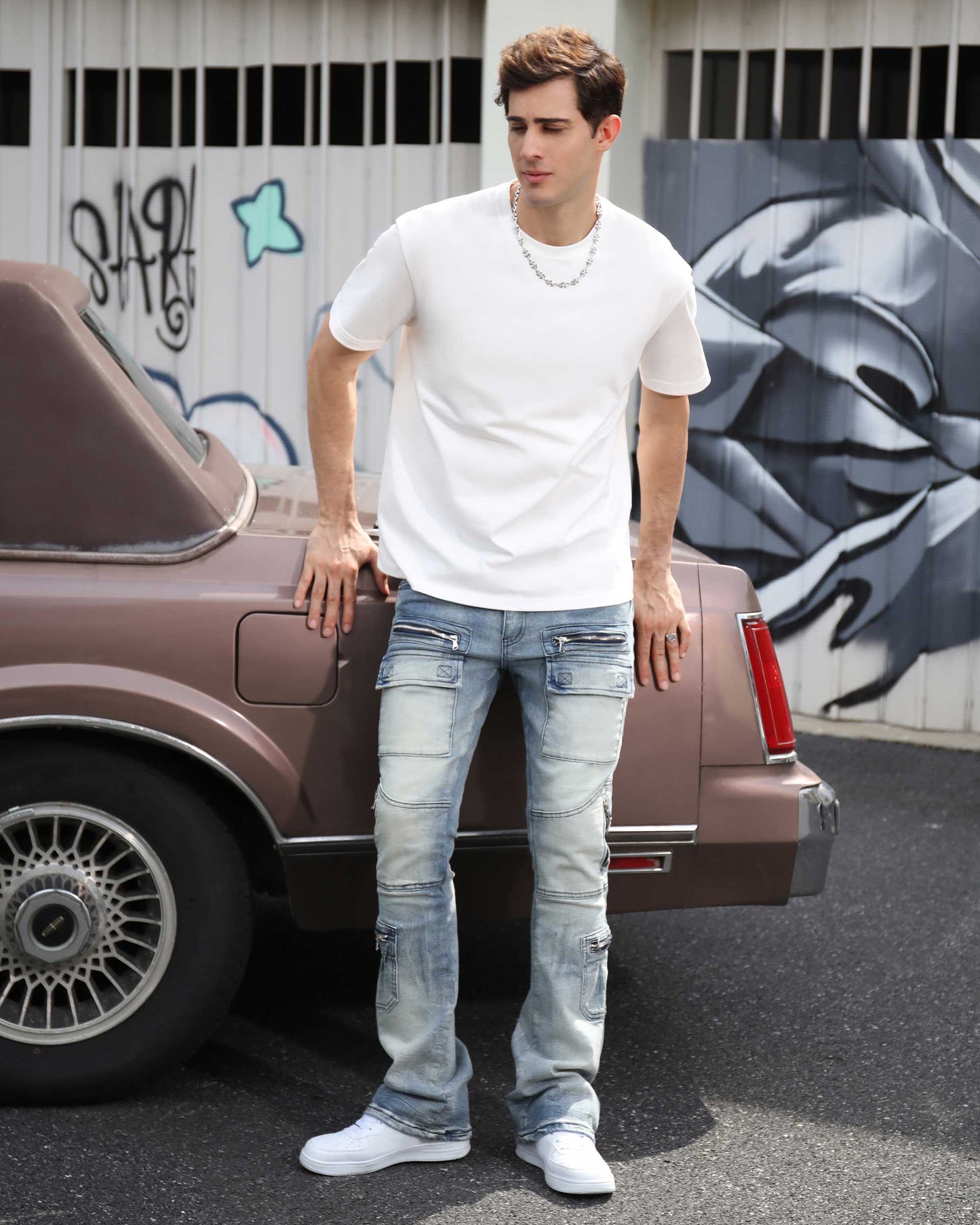 Logeqi light wash distressed cargo jeans styled with a white t-shirt and sneakers outdoors