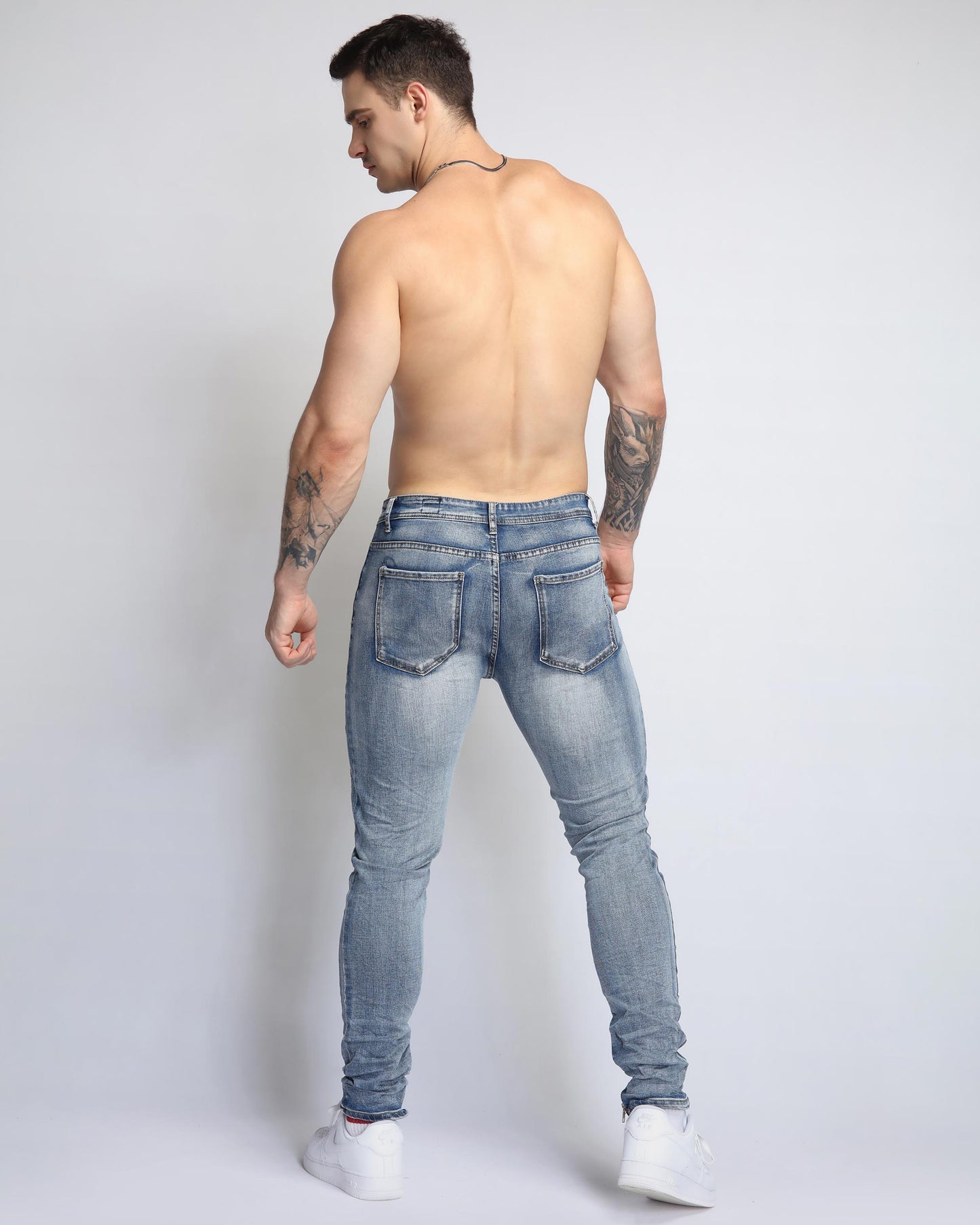 Logeqi light wash ripped jeans on a model, featuring a slim fit and stylish design