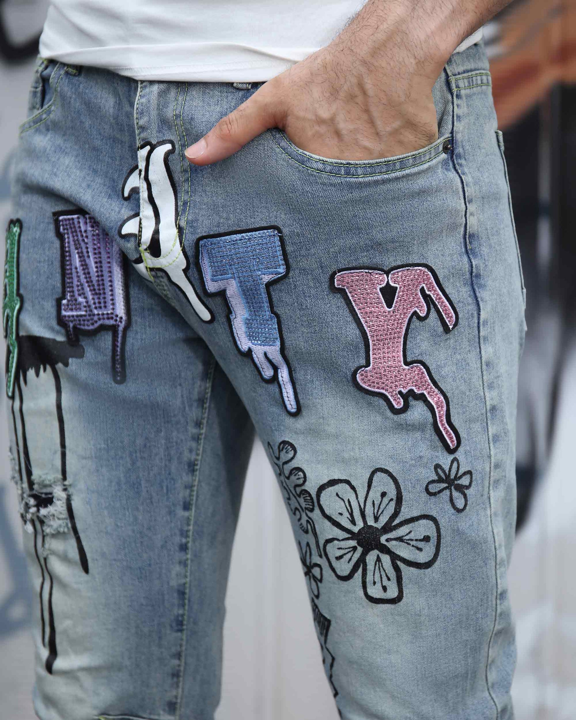 Logeqi light wash street art jeans with colorful patches and floral designs on front
