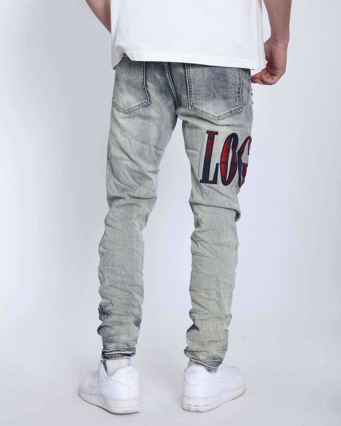 Logeqi light washed ripped jeans featuring distressed detailing and a cool graphic design