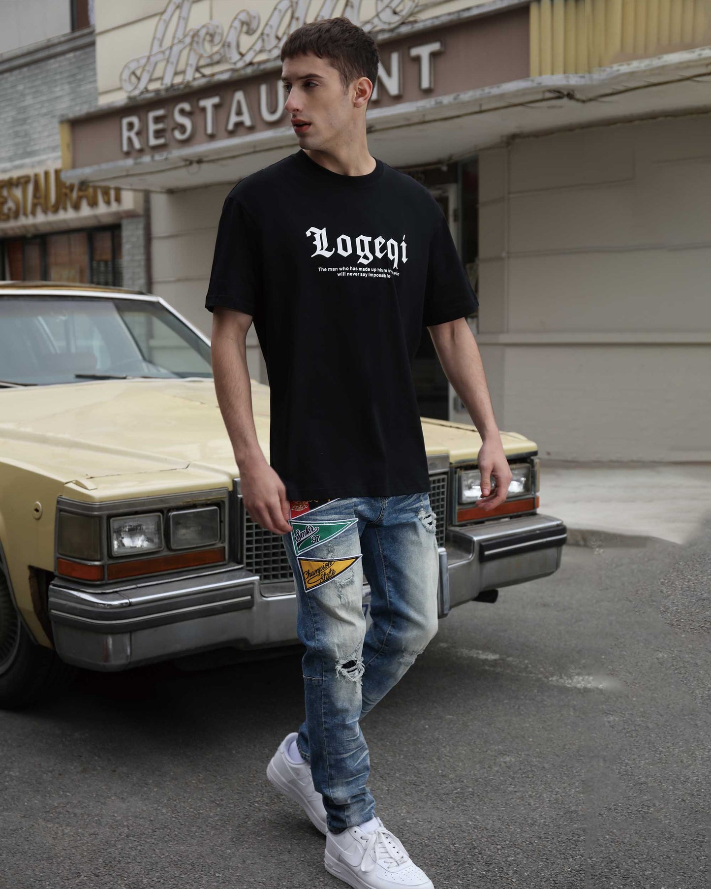 Logeqi medium wash distressed jeans styled with a black t-shirt for a casual street look