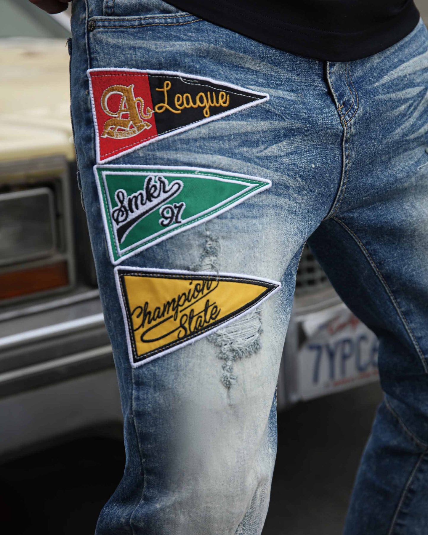 Logeqi medium wash distressed jeans featuring colorful embroidered patches for a stylish look